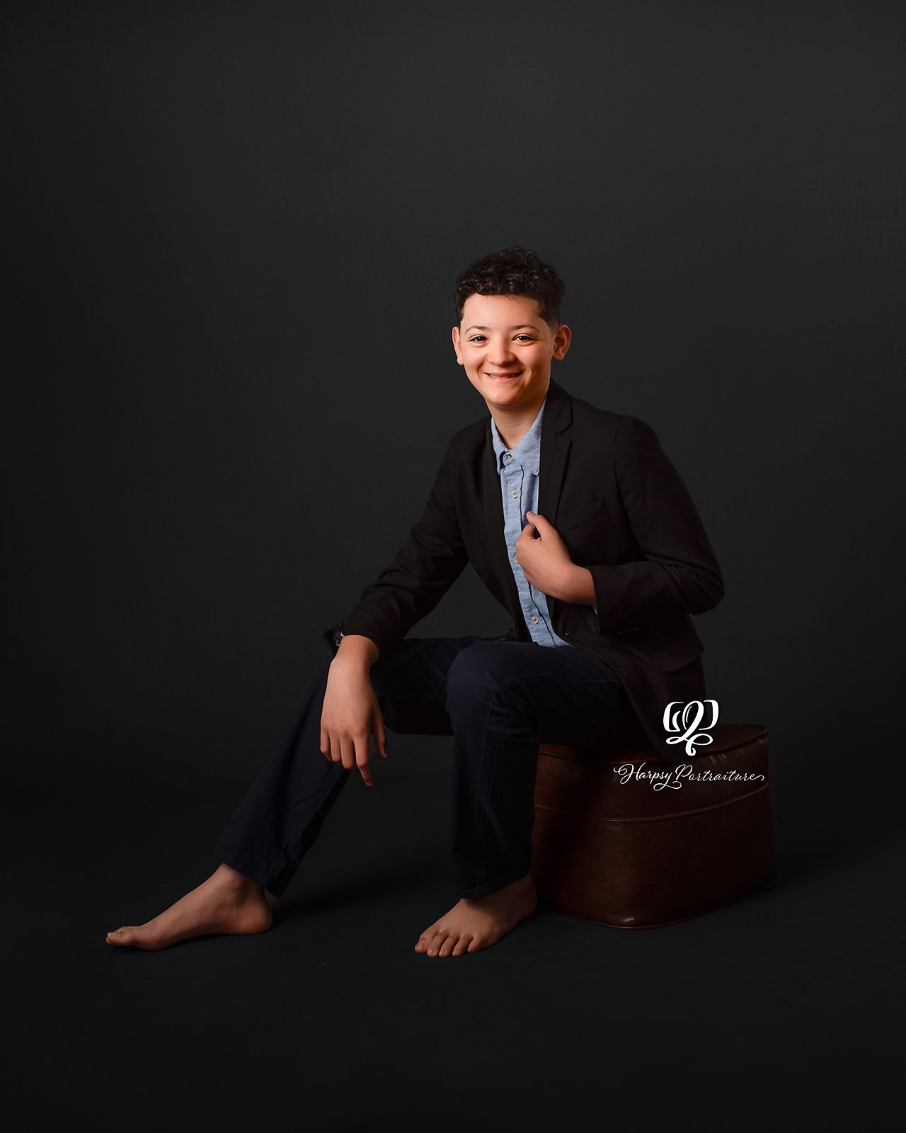 Teen boy posing for portrait wearing suit in Lexington, SC photography studio; best photographer Lexington, SC; children's photographer SC