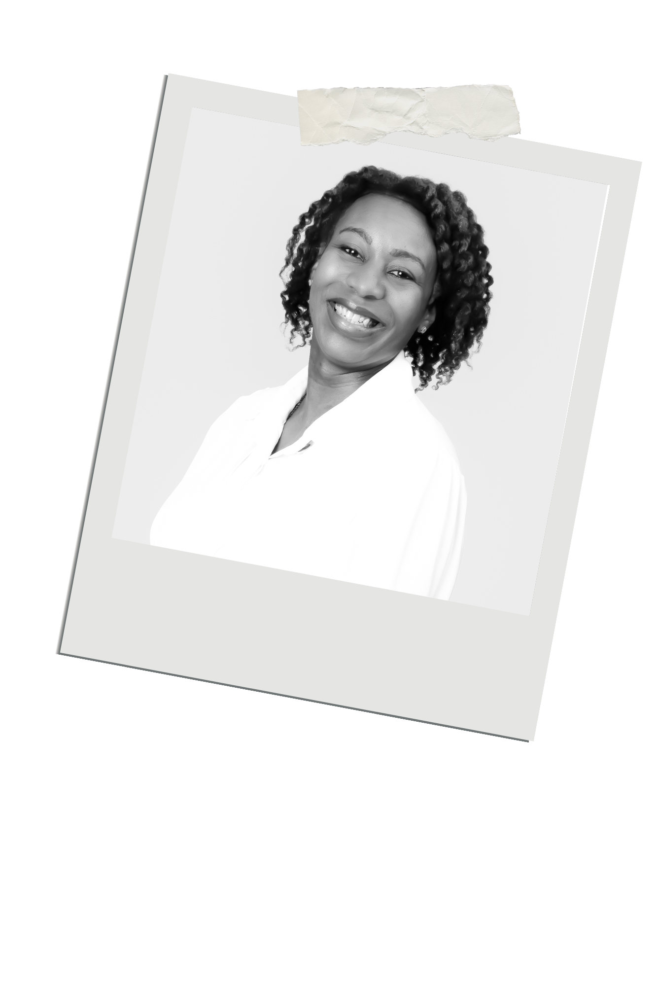 A professional headshot portrait of someone with curly dark hair and a white top smiling warmly against a light background.