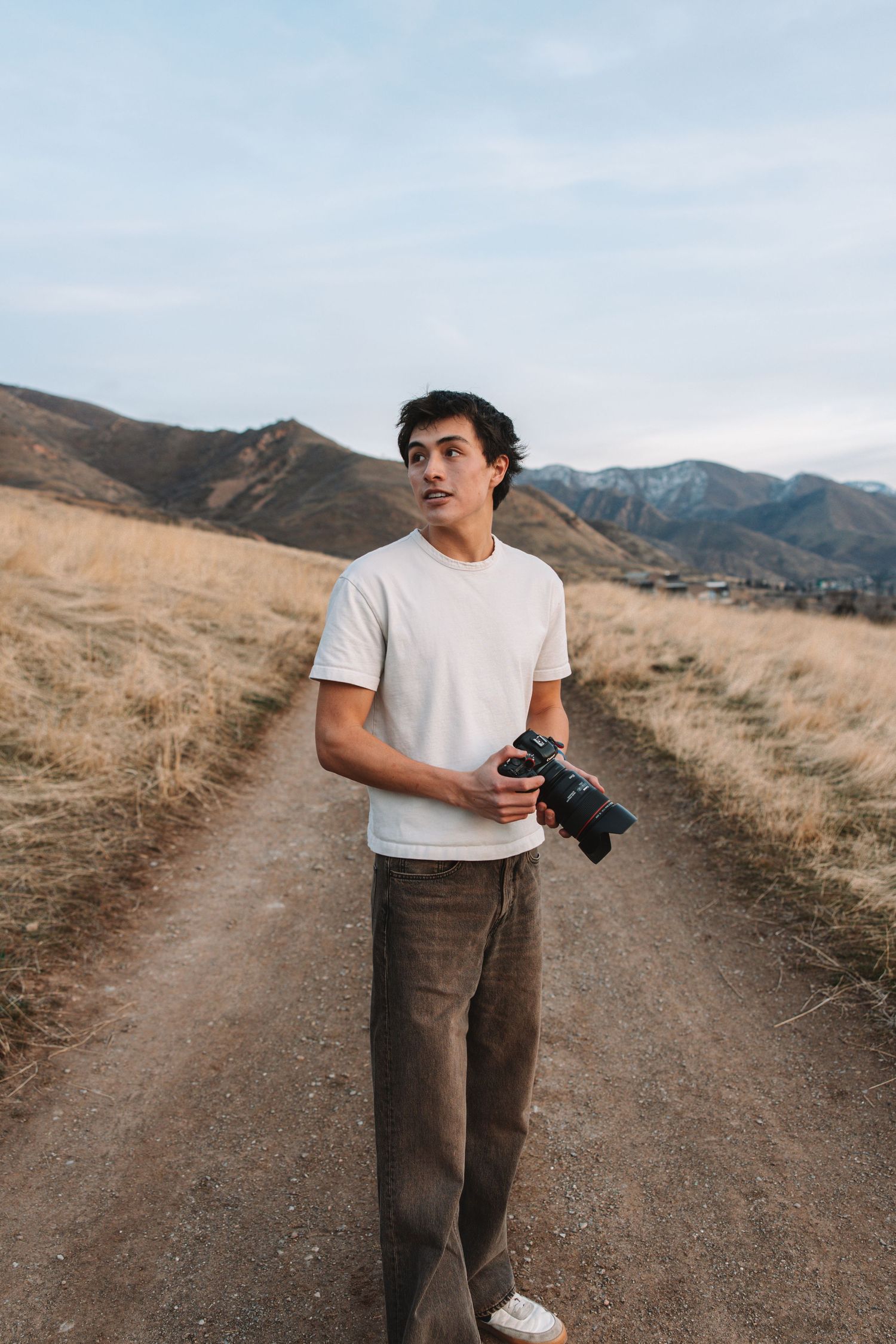 Branding photo of Carson Suttle Photography in SLC, Utah holding a camera.