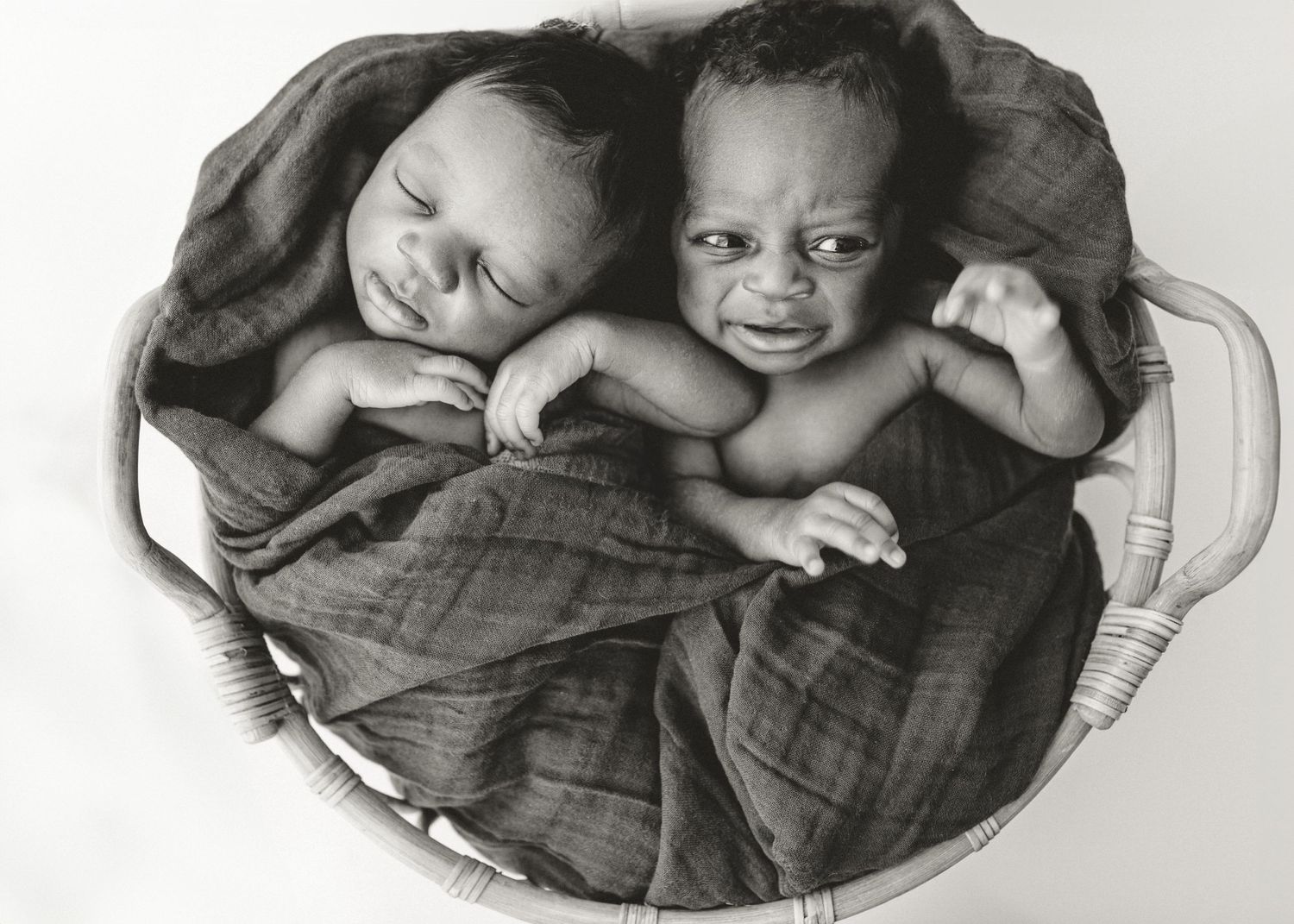 Series of black and white photos showing twin babies sleeping in round baskets.