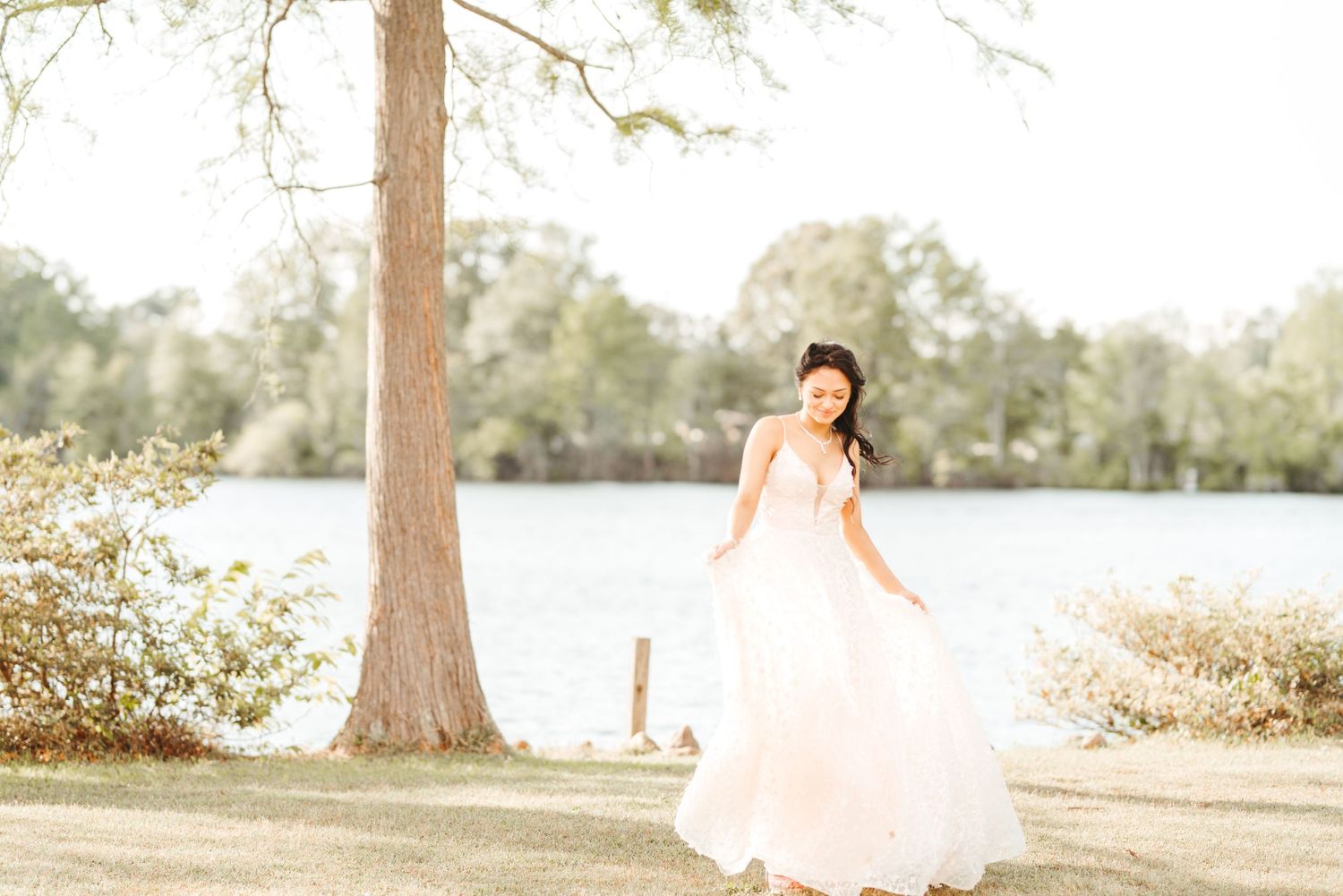 Ethereal outdoor portrait session under trees with soft natural lighting.