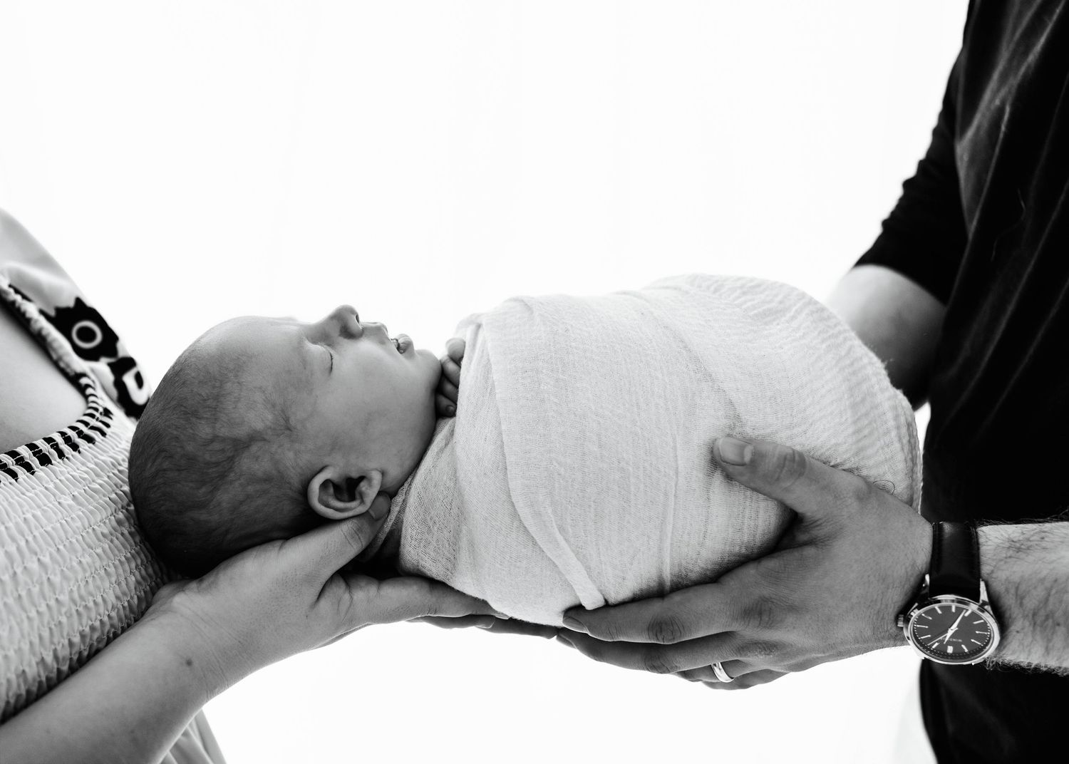 Black and white artistic newborn photography session with minimalist styling.