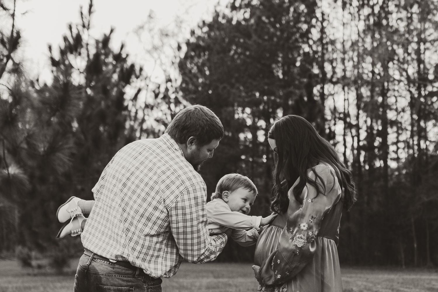 Black and white outdoor portrait session in rustic woodland setting.