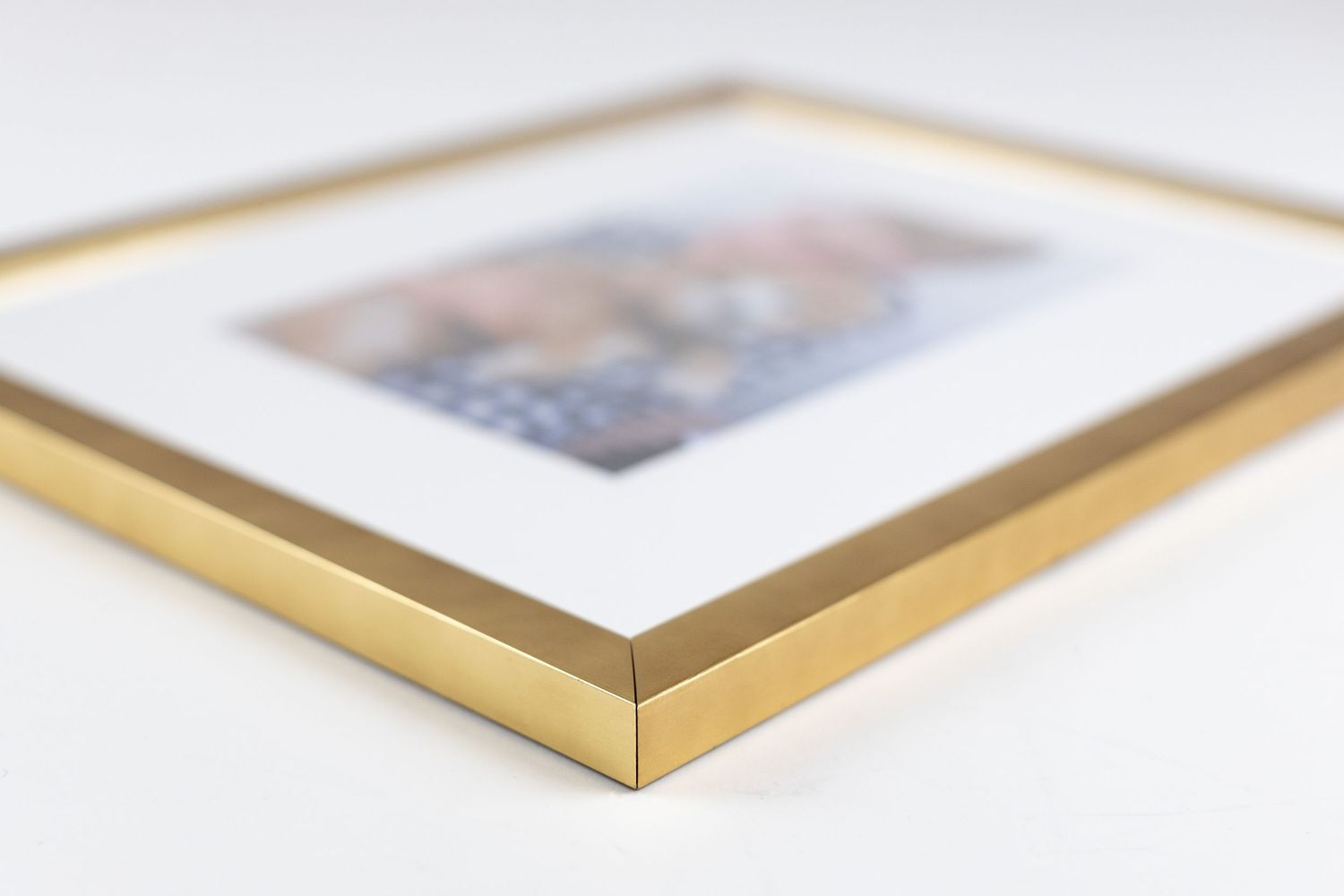 Close-up view of photo print corners showing gold frame detail.