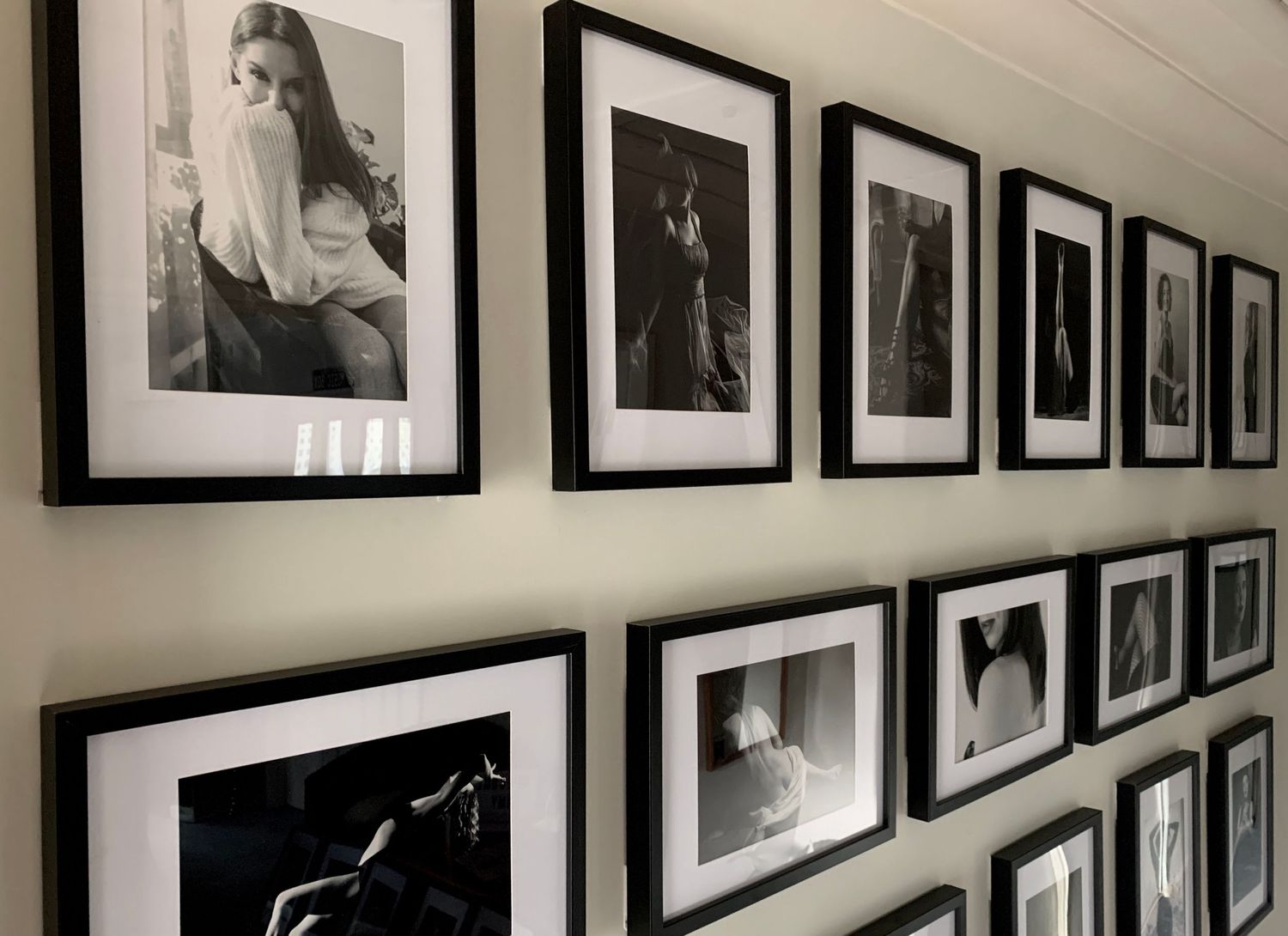 Black and white framed photography prints displayed in a gallery wall arrangement with black frames on a white wall.