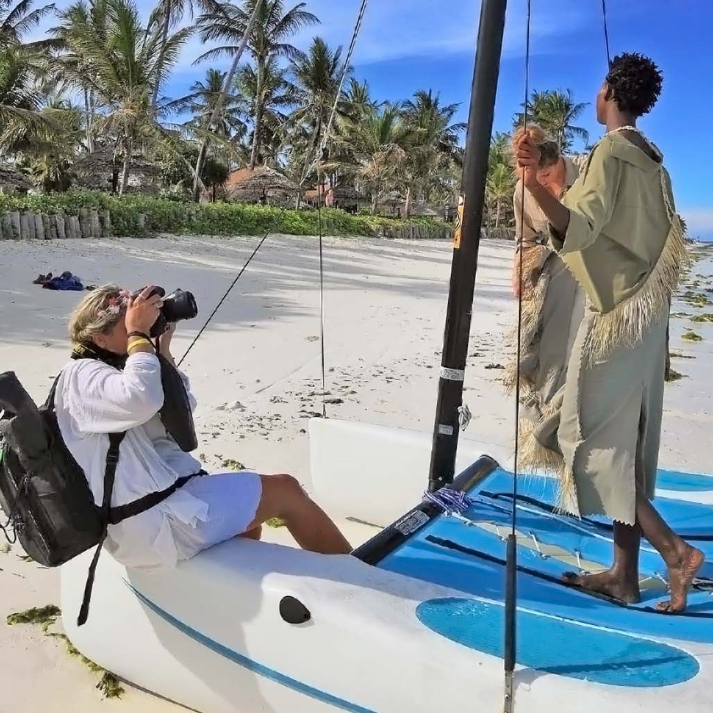Photographer Jana Maillot alias Jana Call me J on a tropical beach of Zanzibar, while a model poses during a fashion shoot.