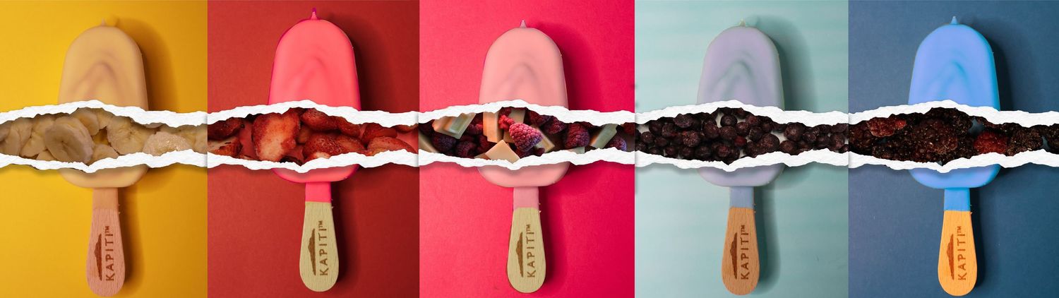Colorful popsicles arranged in a row with torn paper revealing chocolate filling underneath.