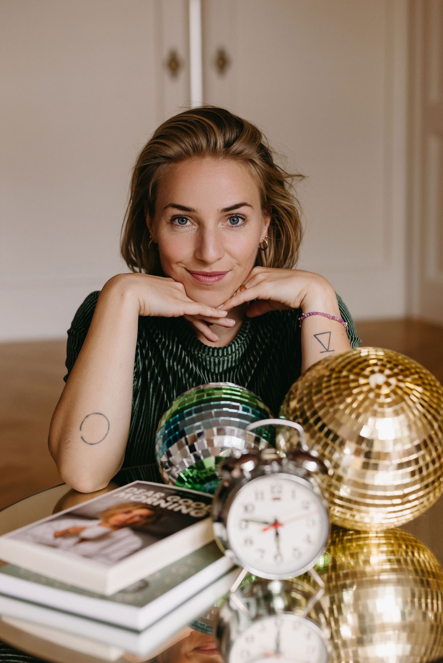 Lifestyle photo with disco balls and alarm clock on table with modern decor.