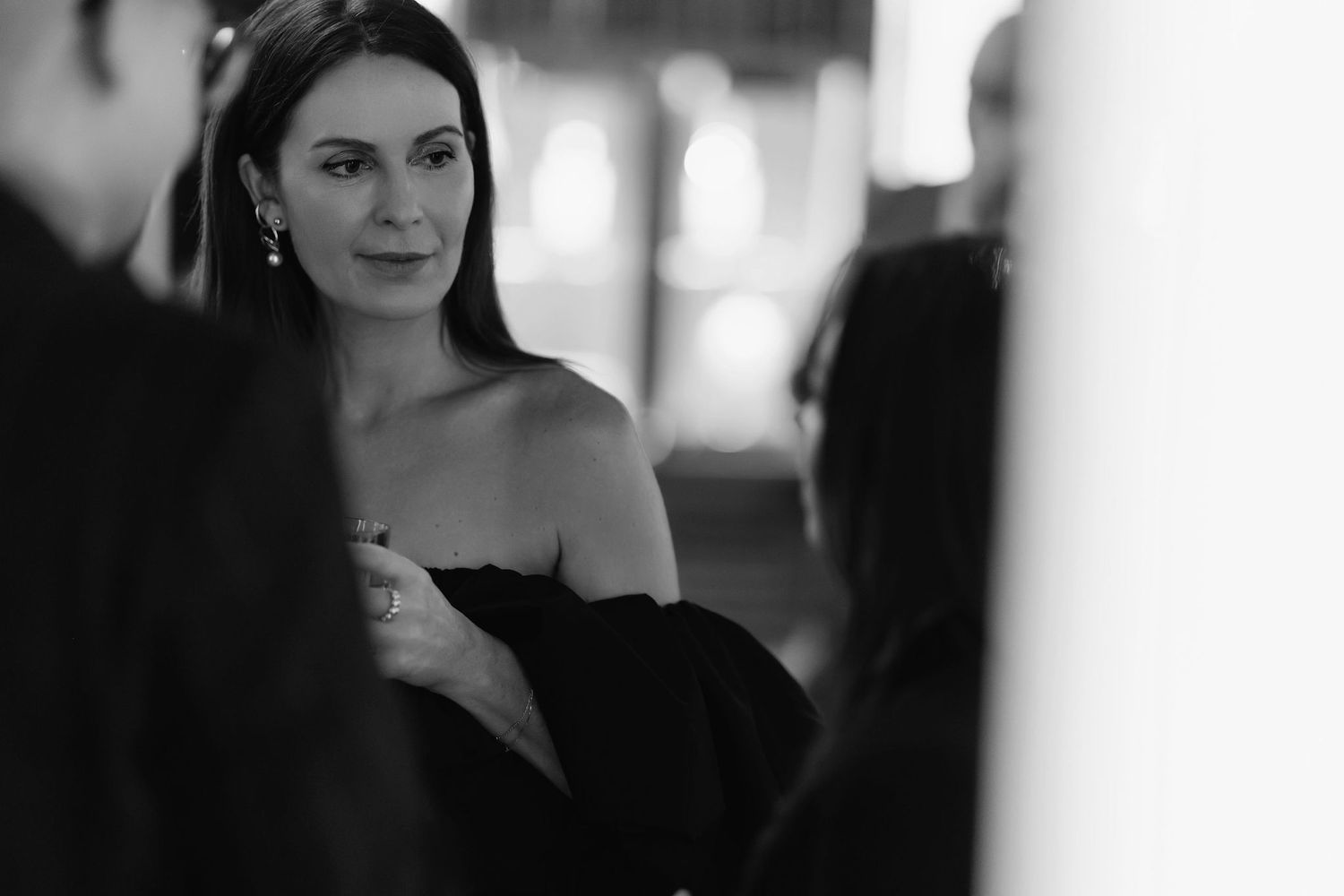 An elegant black and white portrait in a sophisticated evening setting.