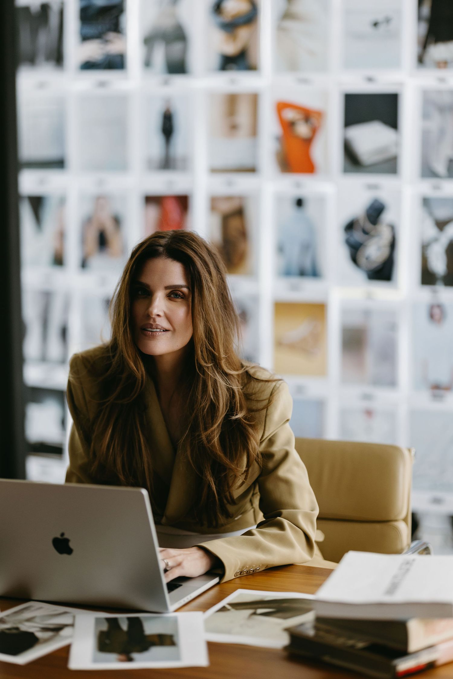 Casual workplace scene with person relaxing near wall of creative photo references.
