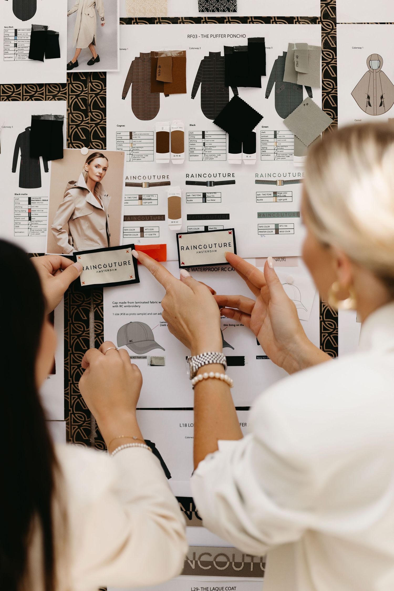 Fashion mood board with clothing sketches and swatches being reviewed by people in white tops.