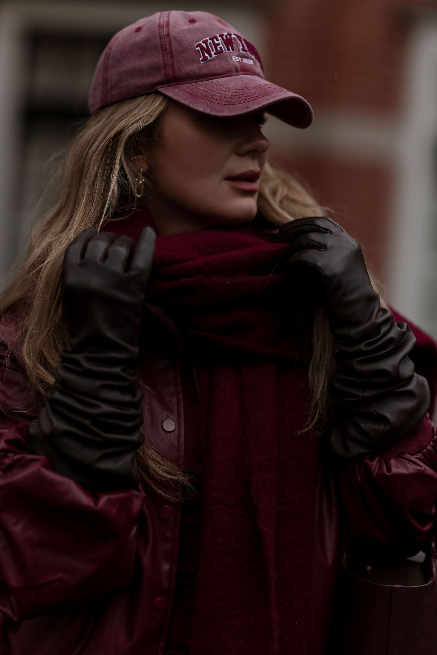 Person wearing a maroon baseball cap and dark jacket in a series of cropped profile shots.