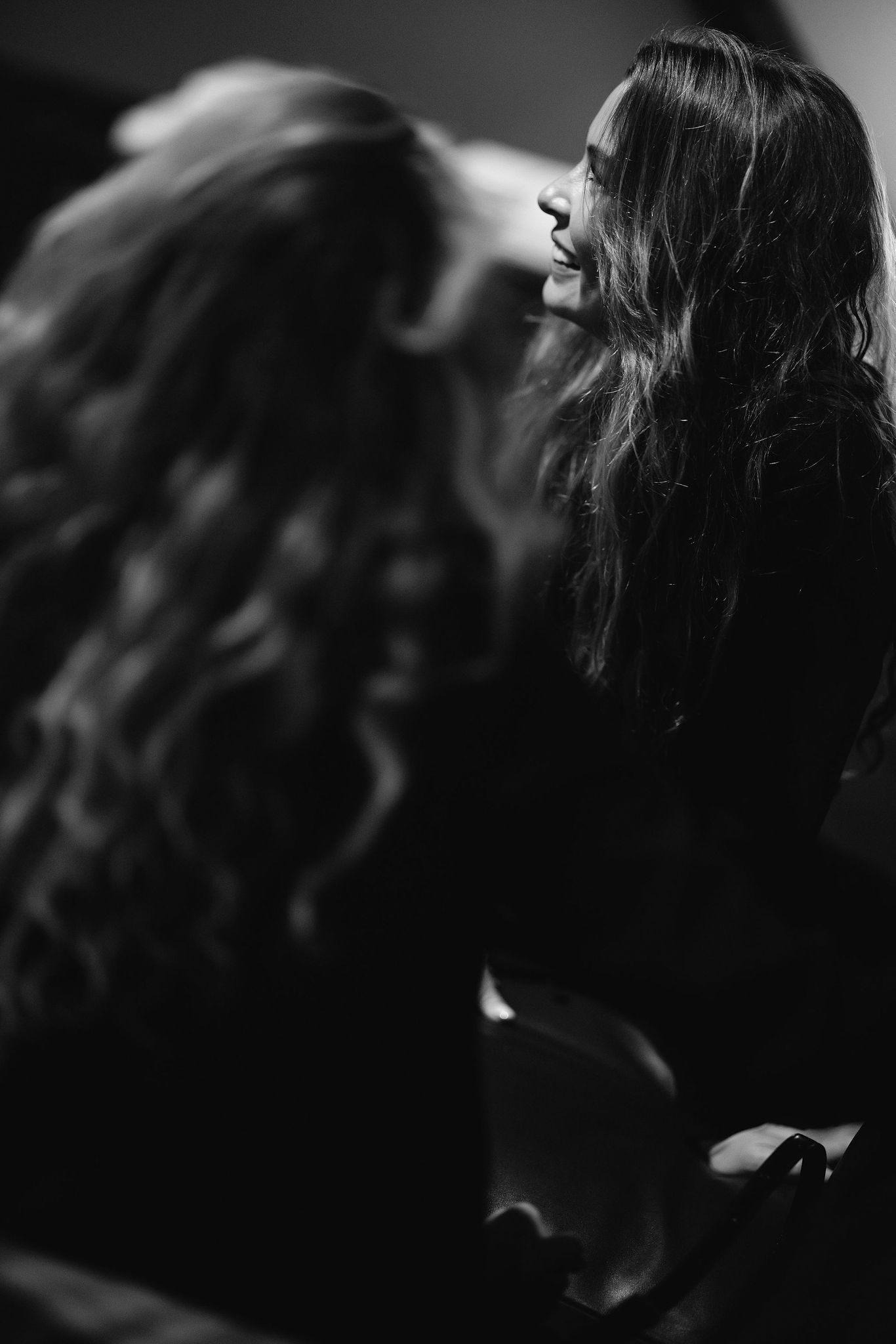 A black and white profile shot of two people in conversation during an event.