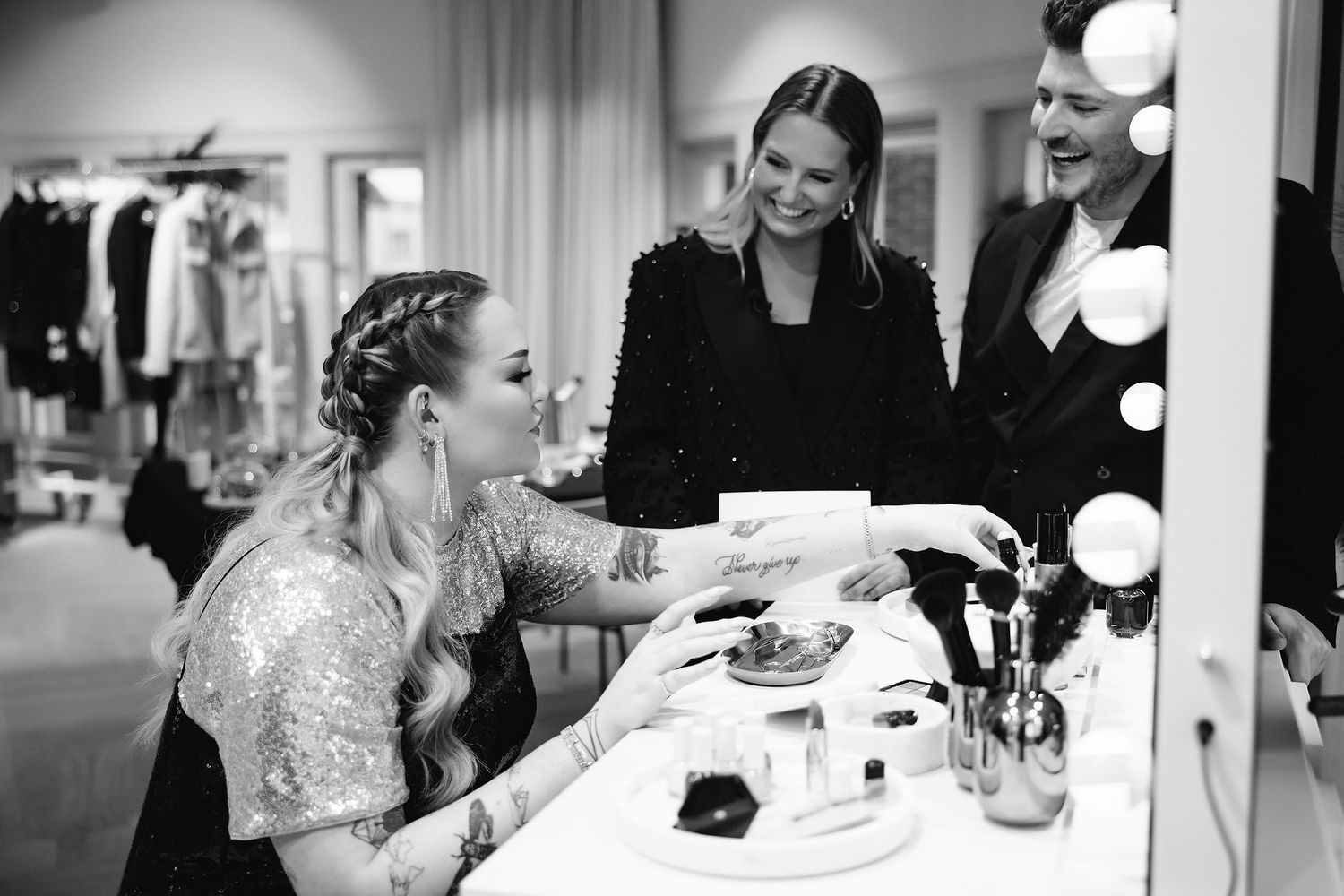 Behind the scenes at a formal event preparation with makeup and styling at illuminated vanity.