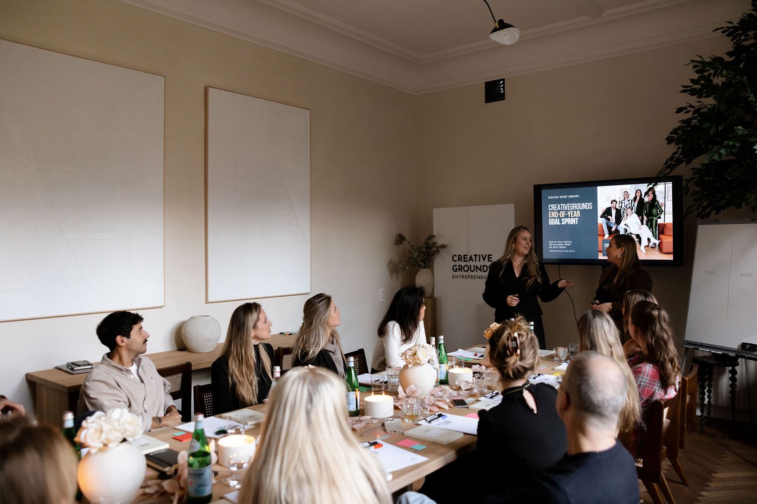 Business meeting or workshop scene with presentation screen in bright modern office space.