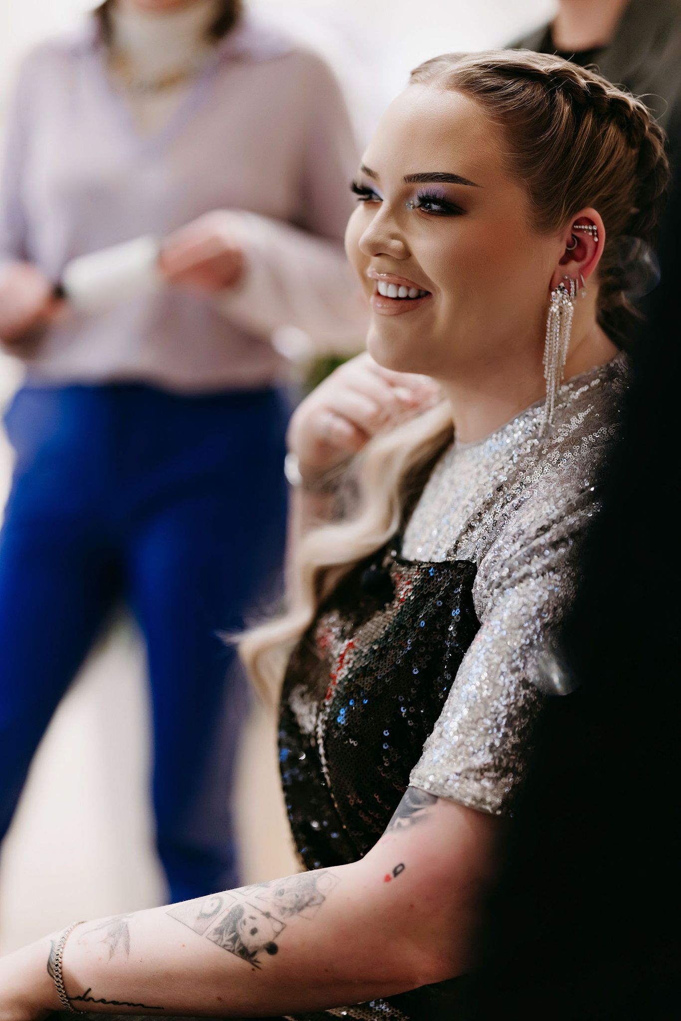 A glamorous formal look comes together as final touches are added to an elegant hairstyle.