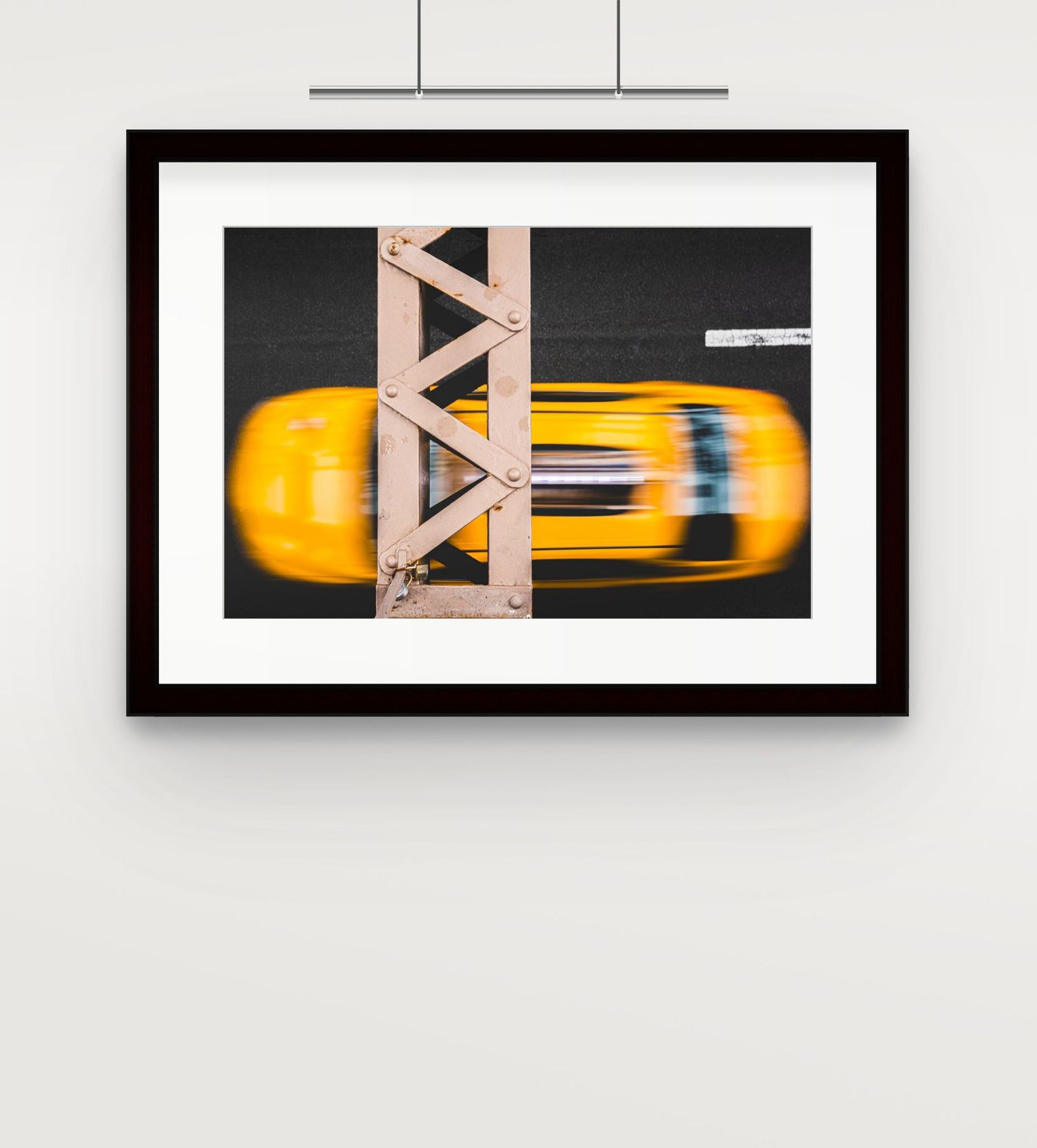 Aerial view framed photo of yellow taxi cab crossing bridge, motion blur effect.
