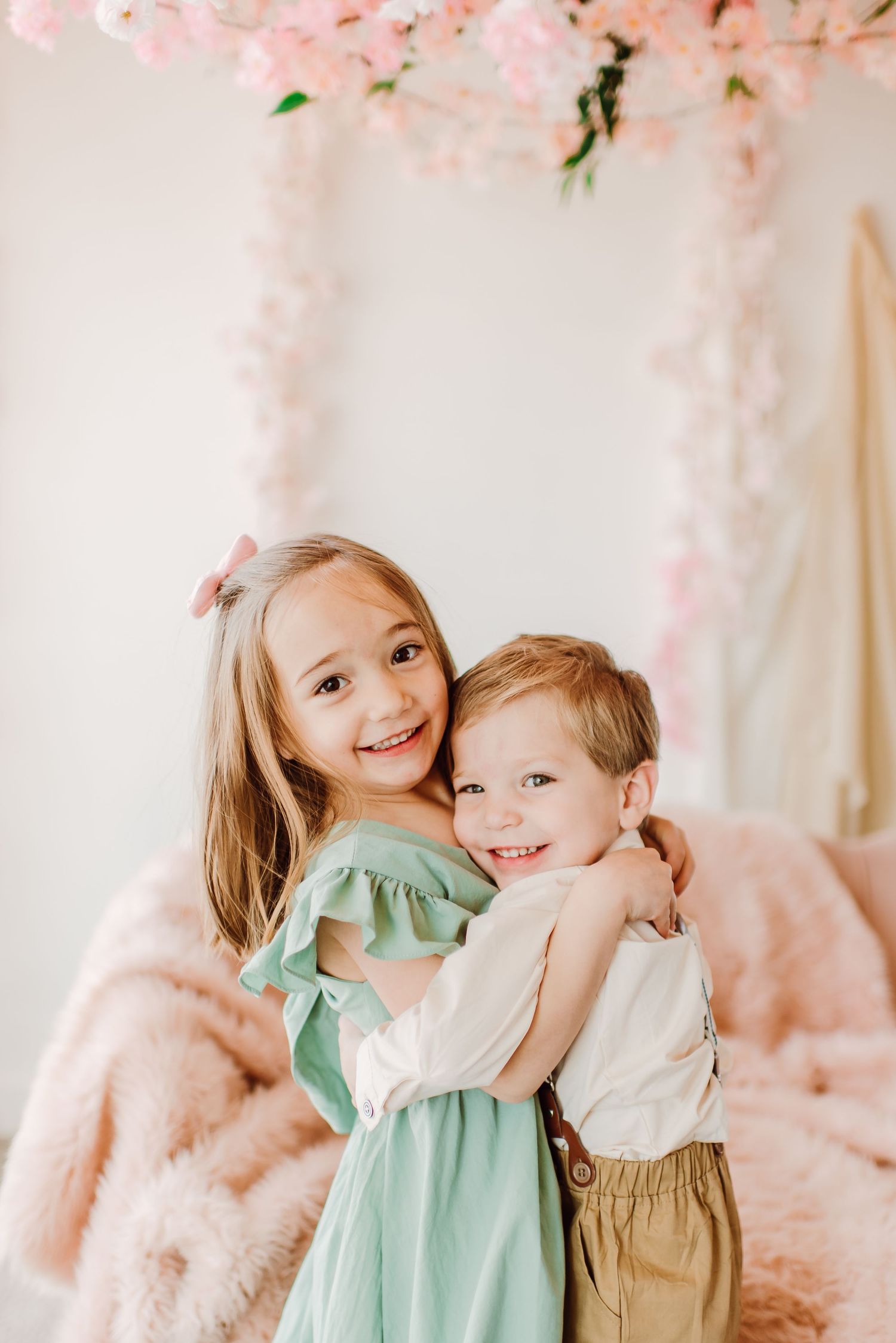 Siblings hugging during family photo session at the studio in Centennial Colorado.