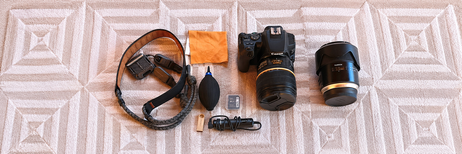 Canon 200D II camera, lenses and everyday photography accessories laid out together as part of my regular photography kit.