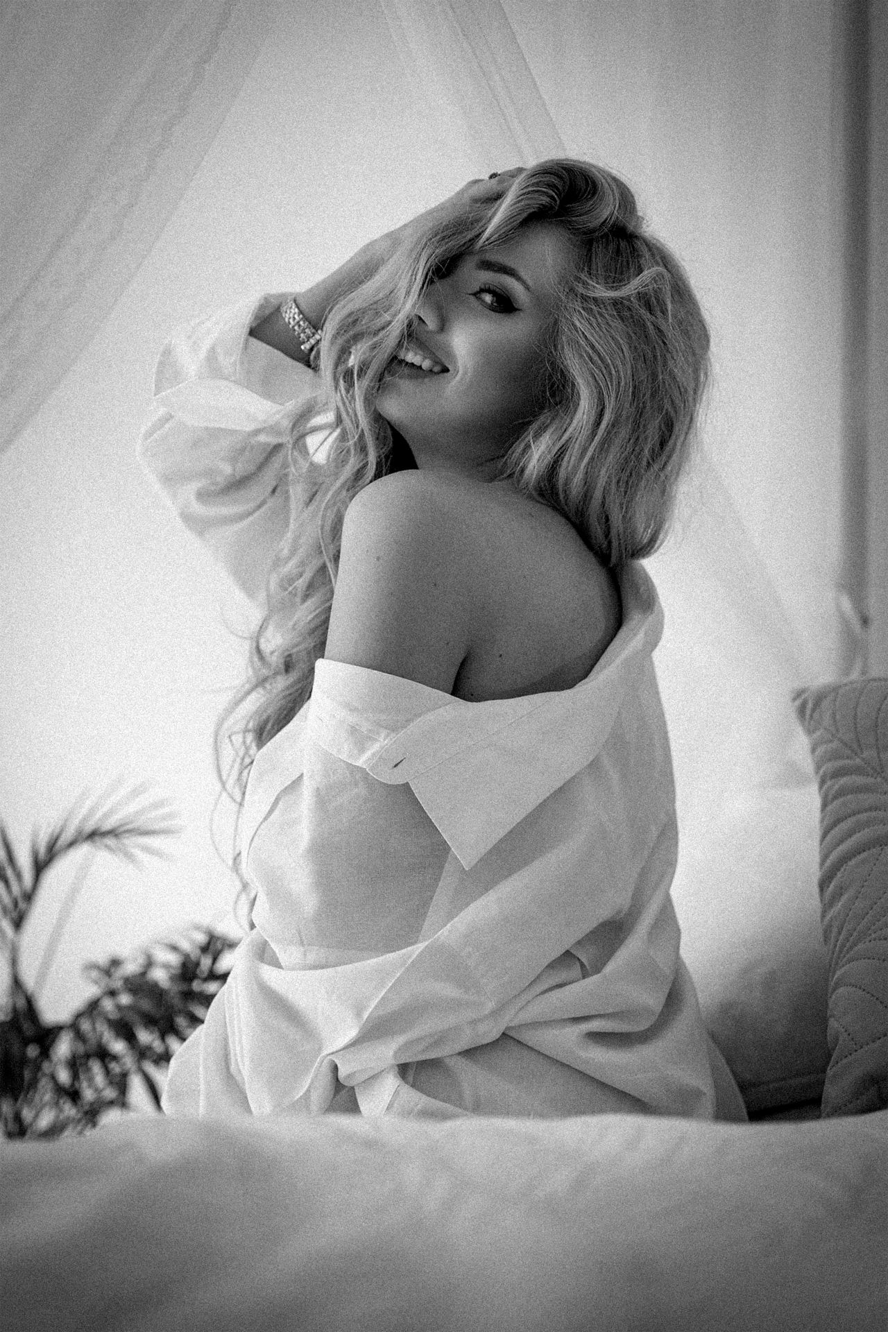 Black and white portrait of a woman wearing an oversized white shirt, fine art women's photography