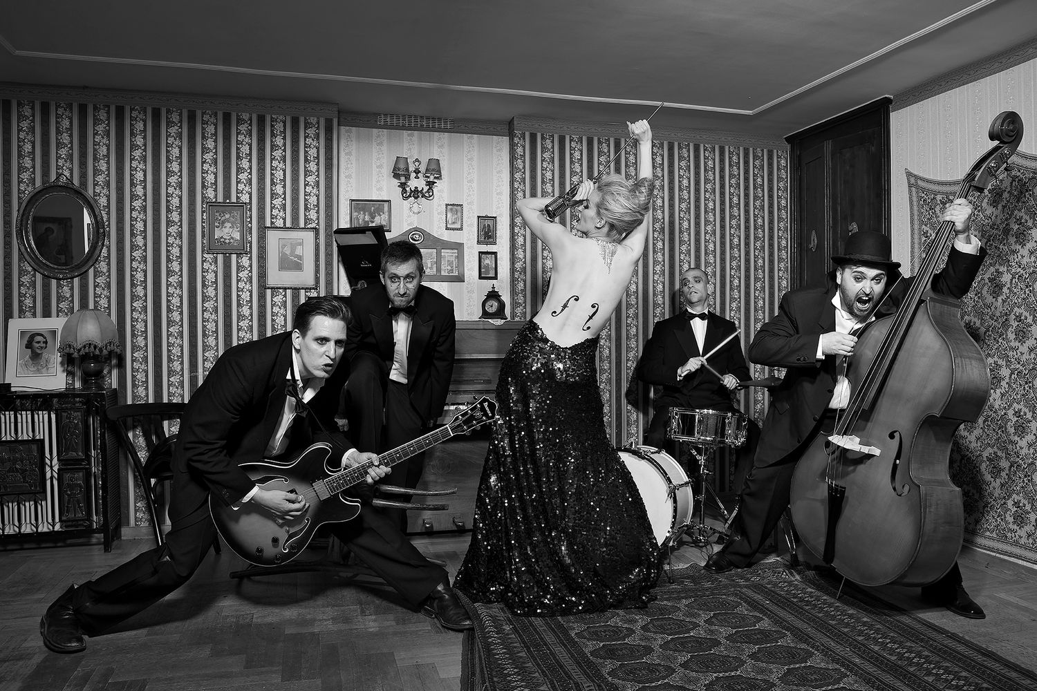 Vintage black and white band photo featuring musicians with guitar, double bass, and a dancing woman.