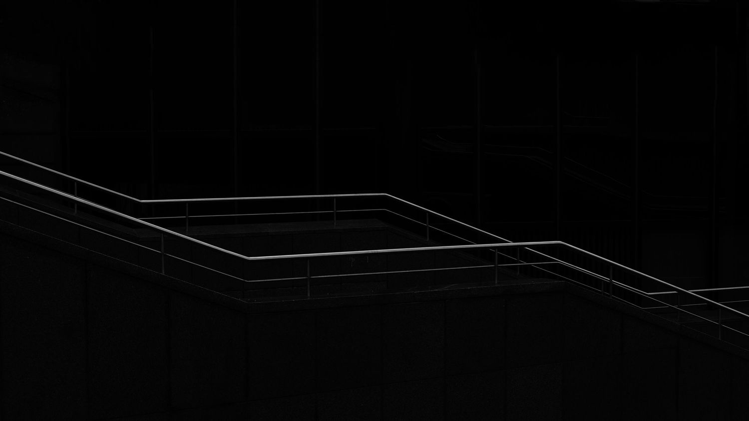 Abstract dark geometric wireframe design with glowing white lines forming a 3D square shape on black background.