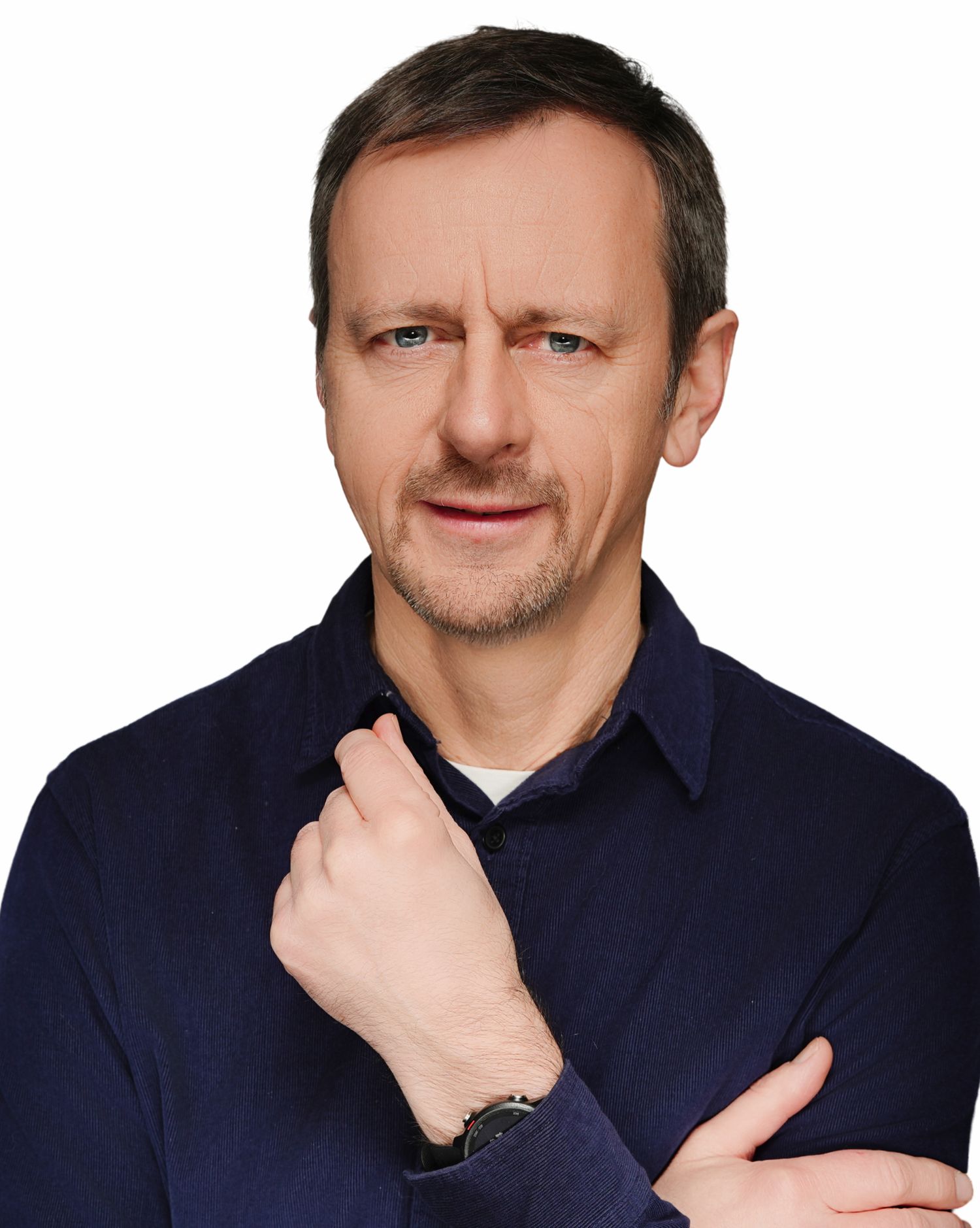 Professional headshot portrait of person in navy polo shirt with thoughtful expression against white background.