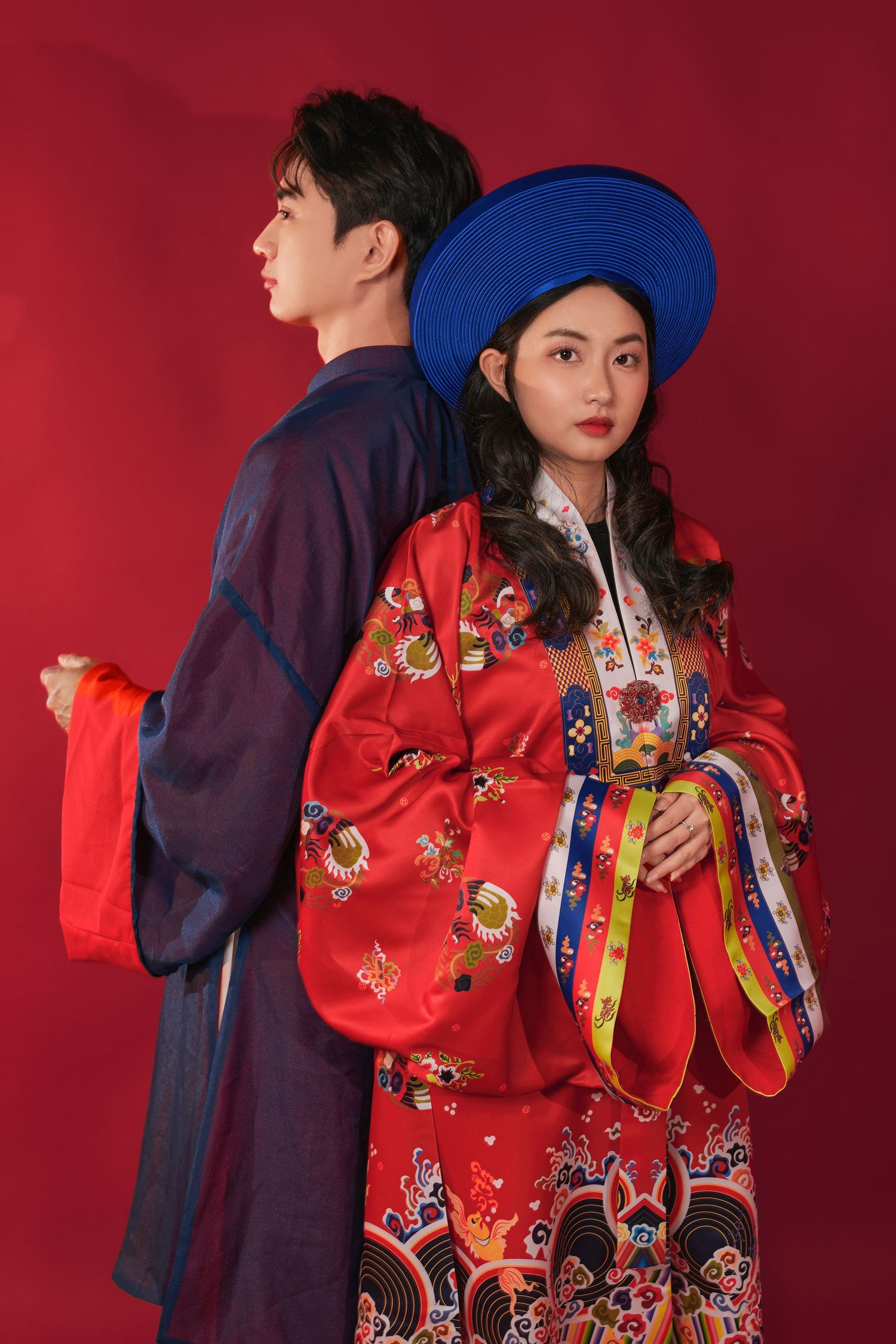 Vietnamese couple in red ao dai and traditional headwear at their tea ceremony, Winnipeg wedding photography