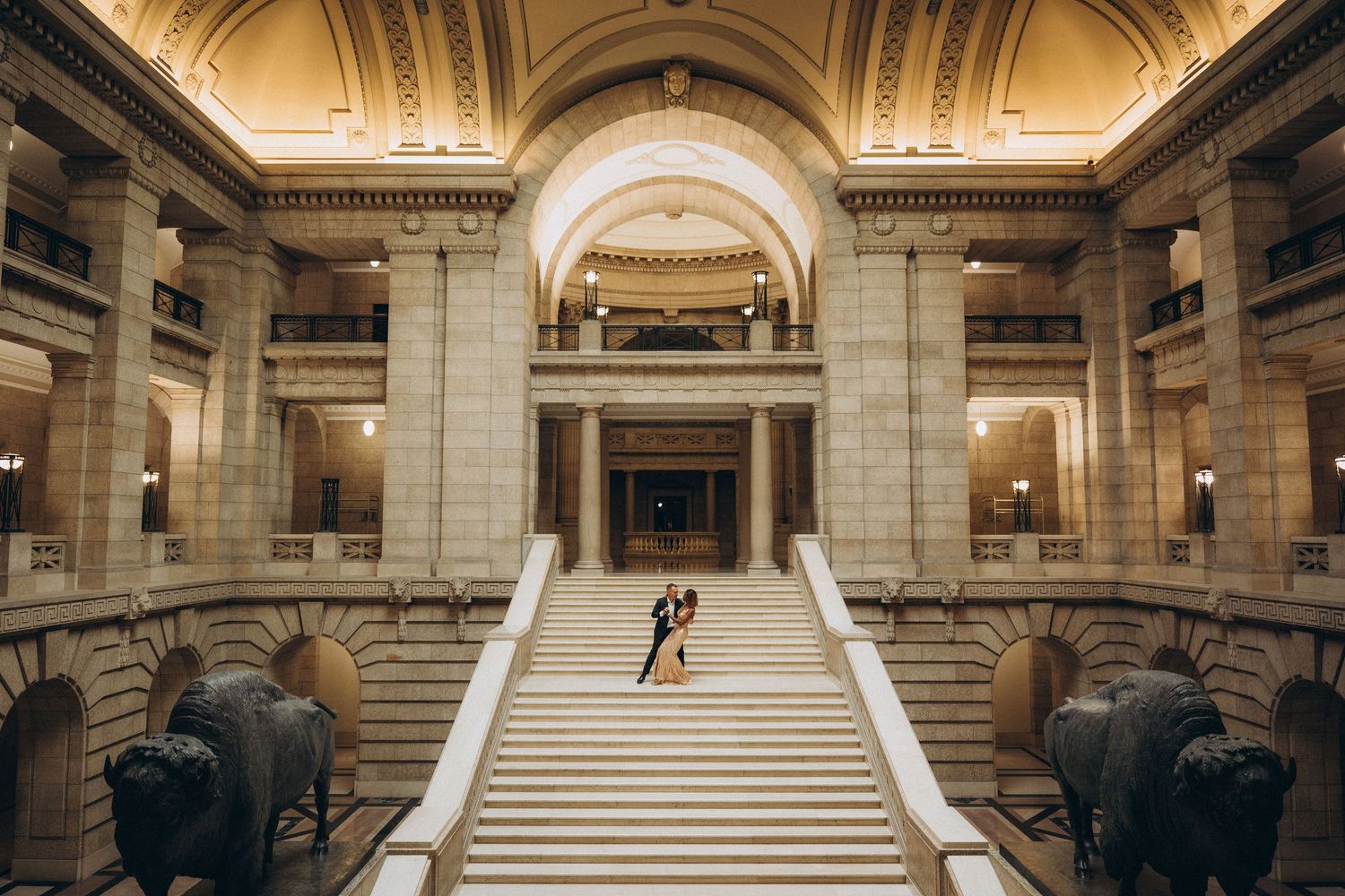 Bride and groom on the marble staircase at the Manitoba Legislative Building Winnipeg