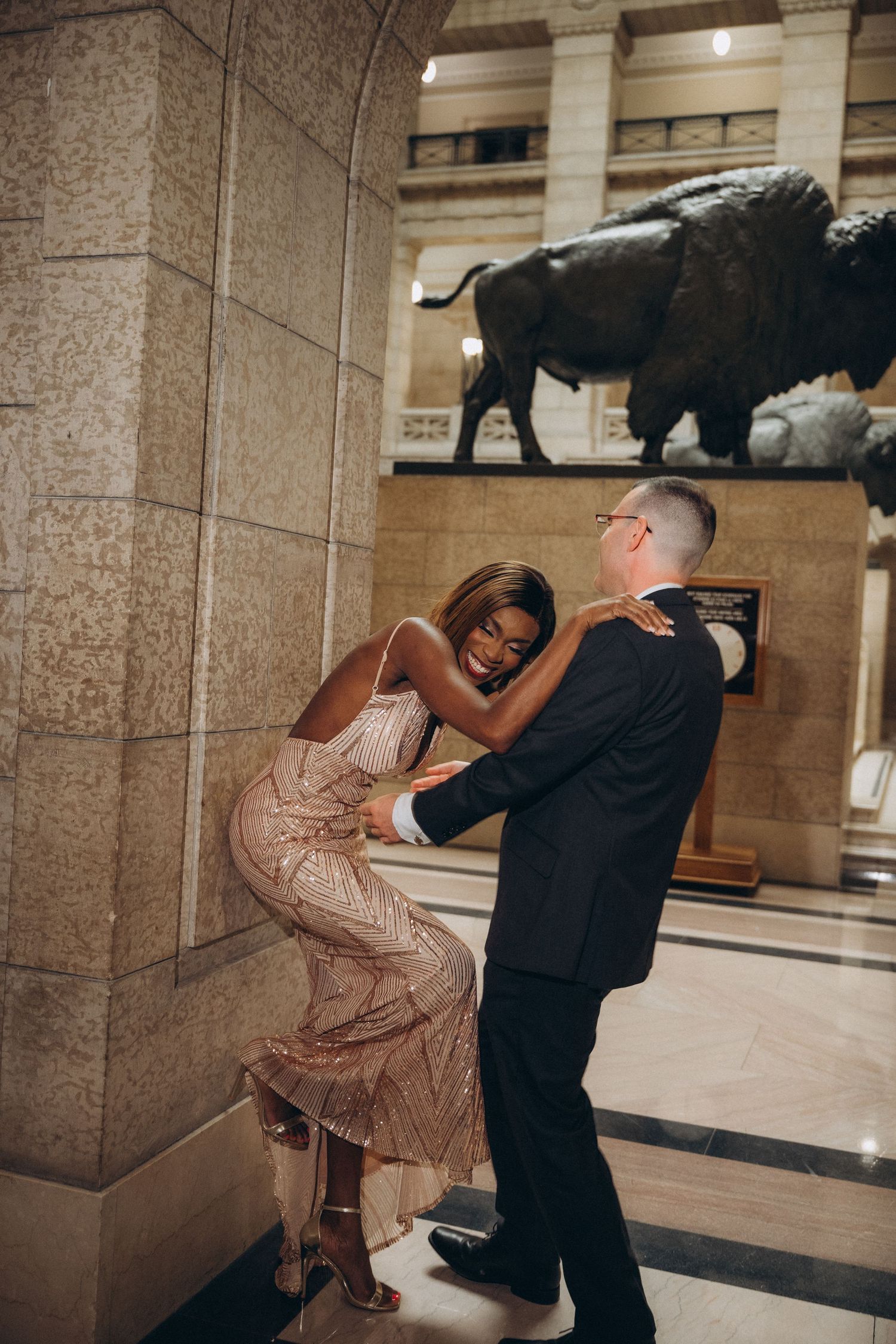 Bride and groom in front of ornate wooden doors at the Manitoba Legislative Building Winnipeg