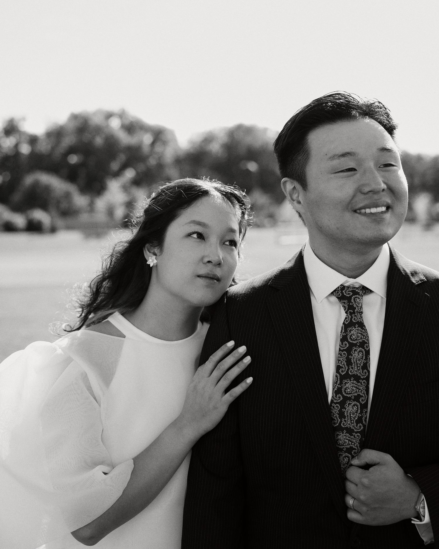 Black and white photo of bride and groom laughing outdoors in Winnipeg
Wedding guests congratulating the couple at an outdoor ceremony in Wi