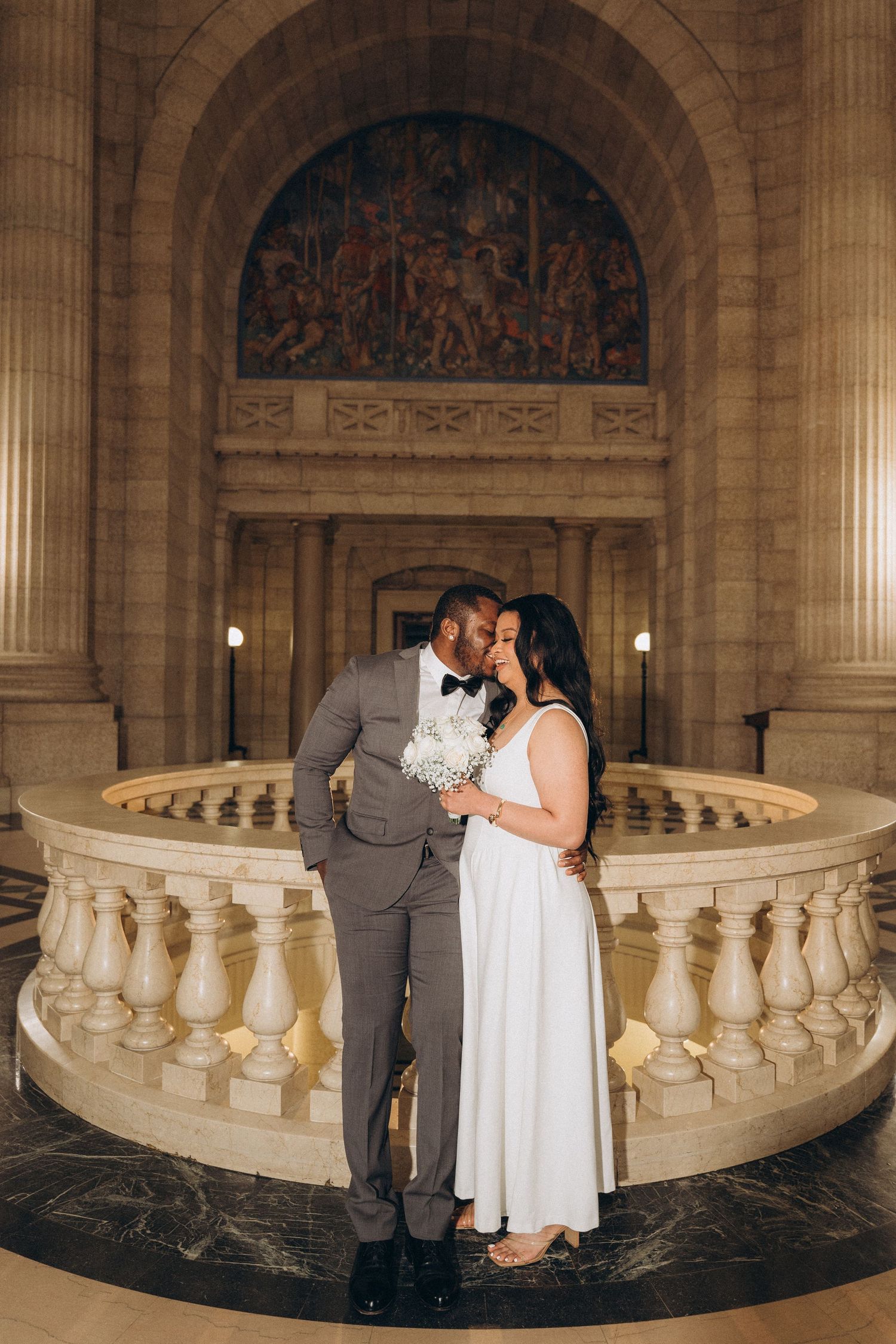 Couple embracing inside the Manitoba Legislative Building during their Winnipeg elopement