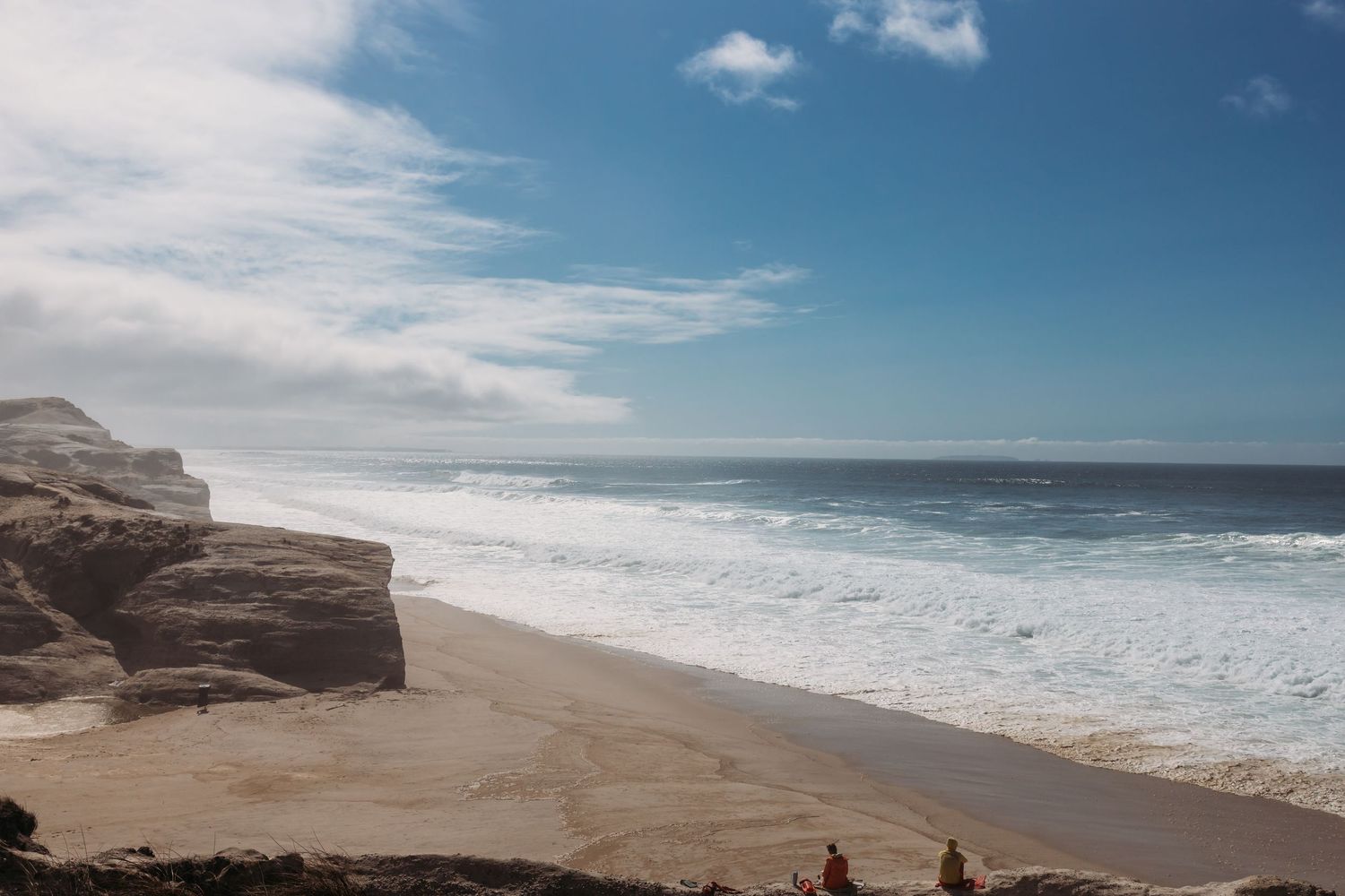 large open windswept beach with rough seas