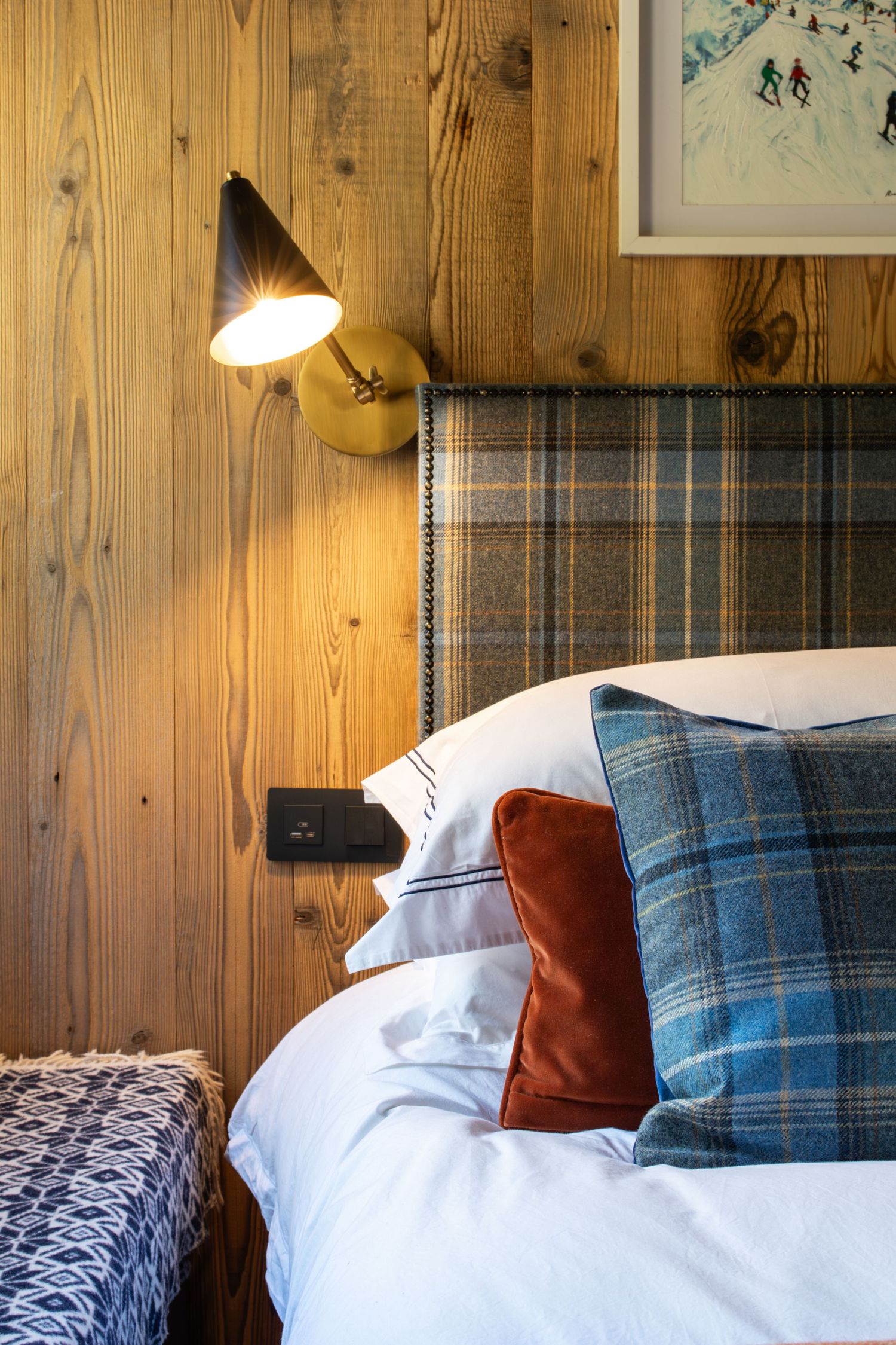 Burberry headboard and bed linen with wall mounted lamp