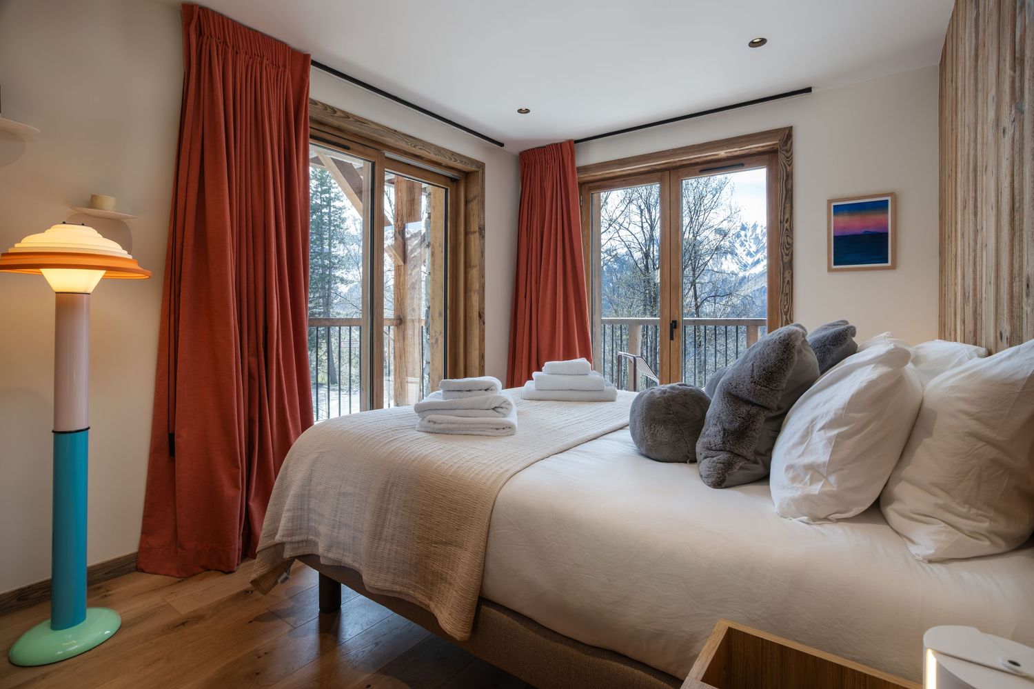 view across double bed looking out of full length window in ski resort