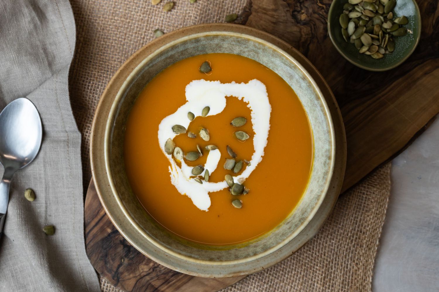 bowl of red soup with pumpkin seeds