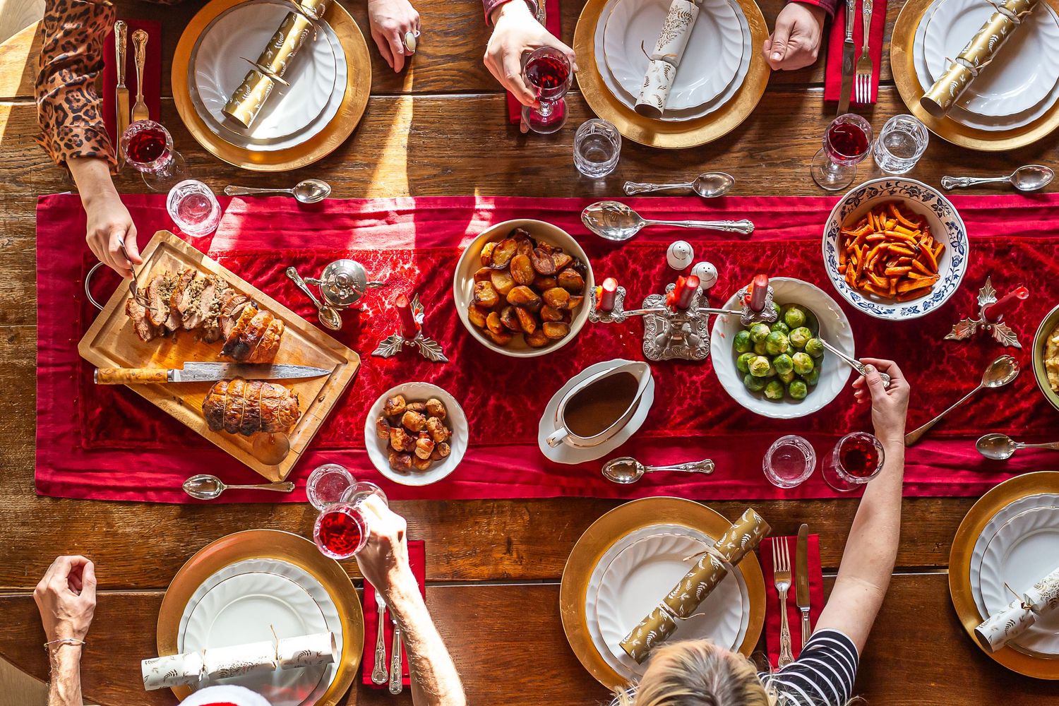 hands reach across Christmas lunch table