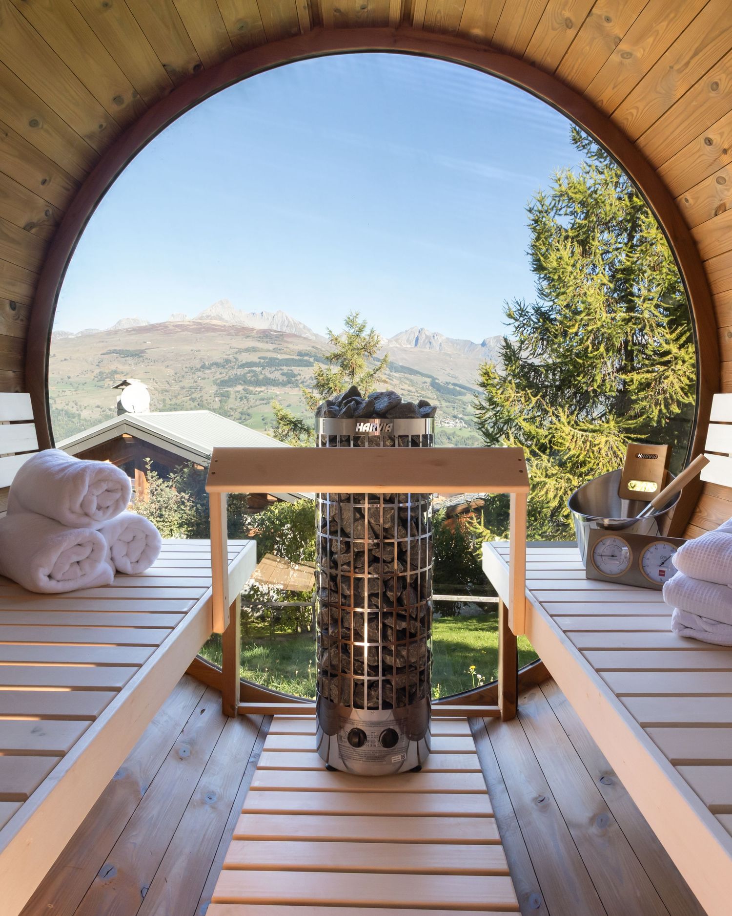 transparent end of sauna over looking mountain range in French alps