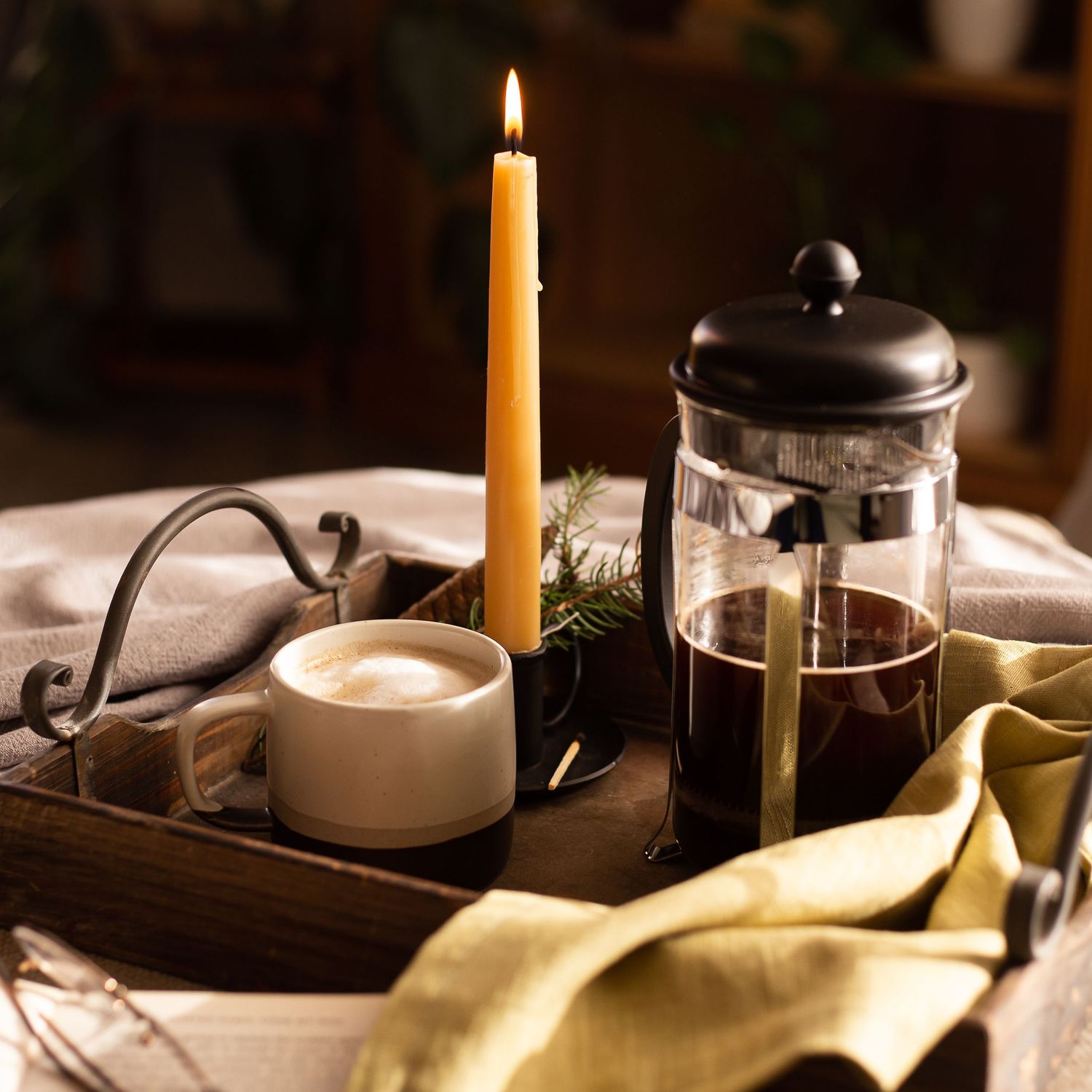 cafetiere and mug of coffee and candle stick on tray