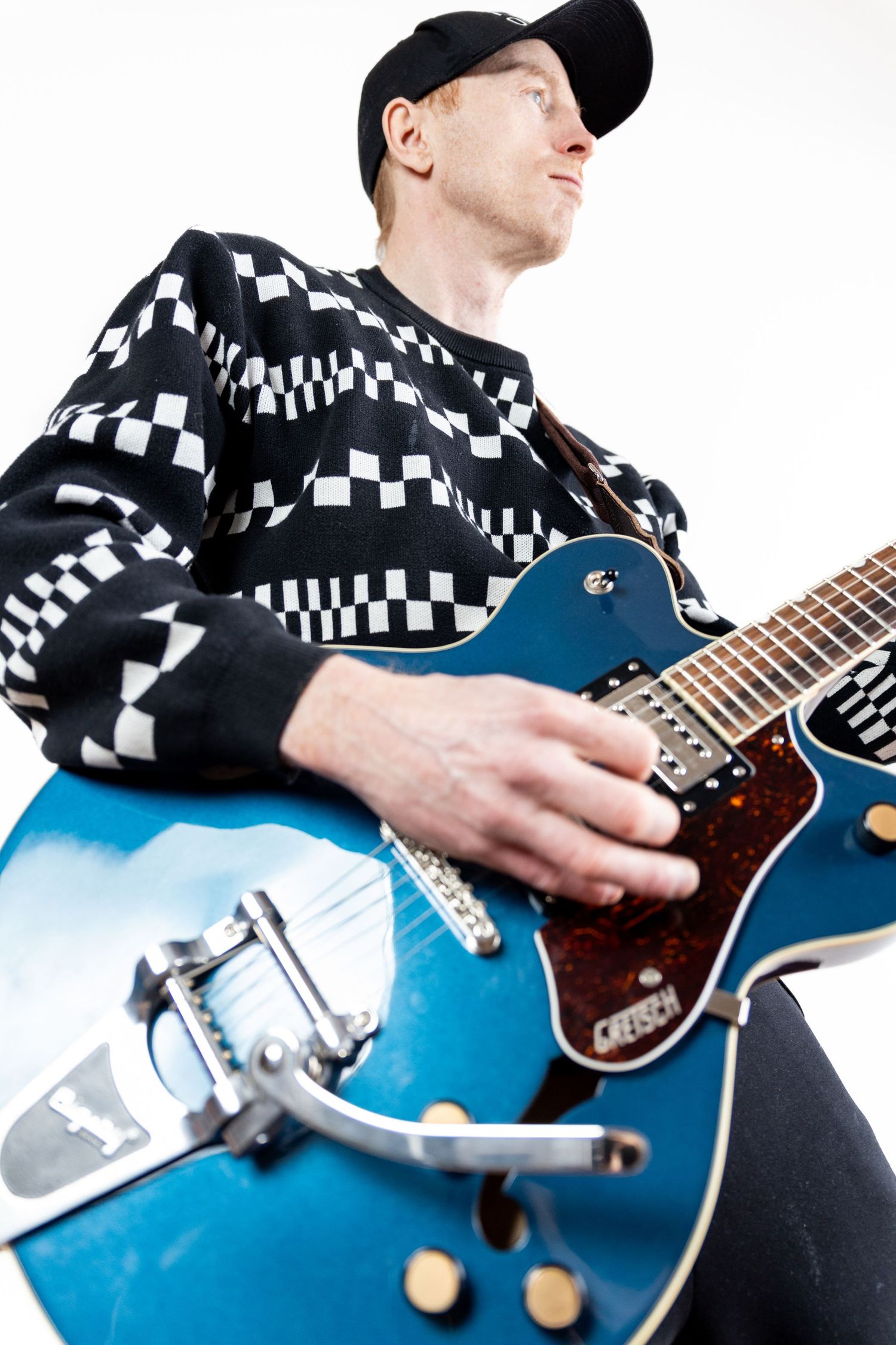 man playing blue guitar