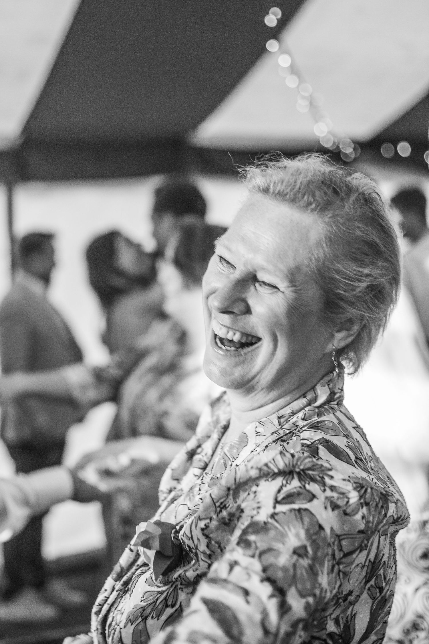 middle aged woman laughing at daughters wedding