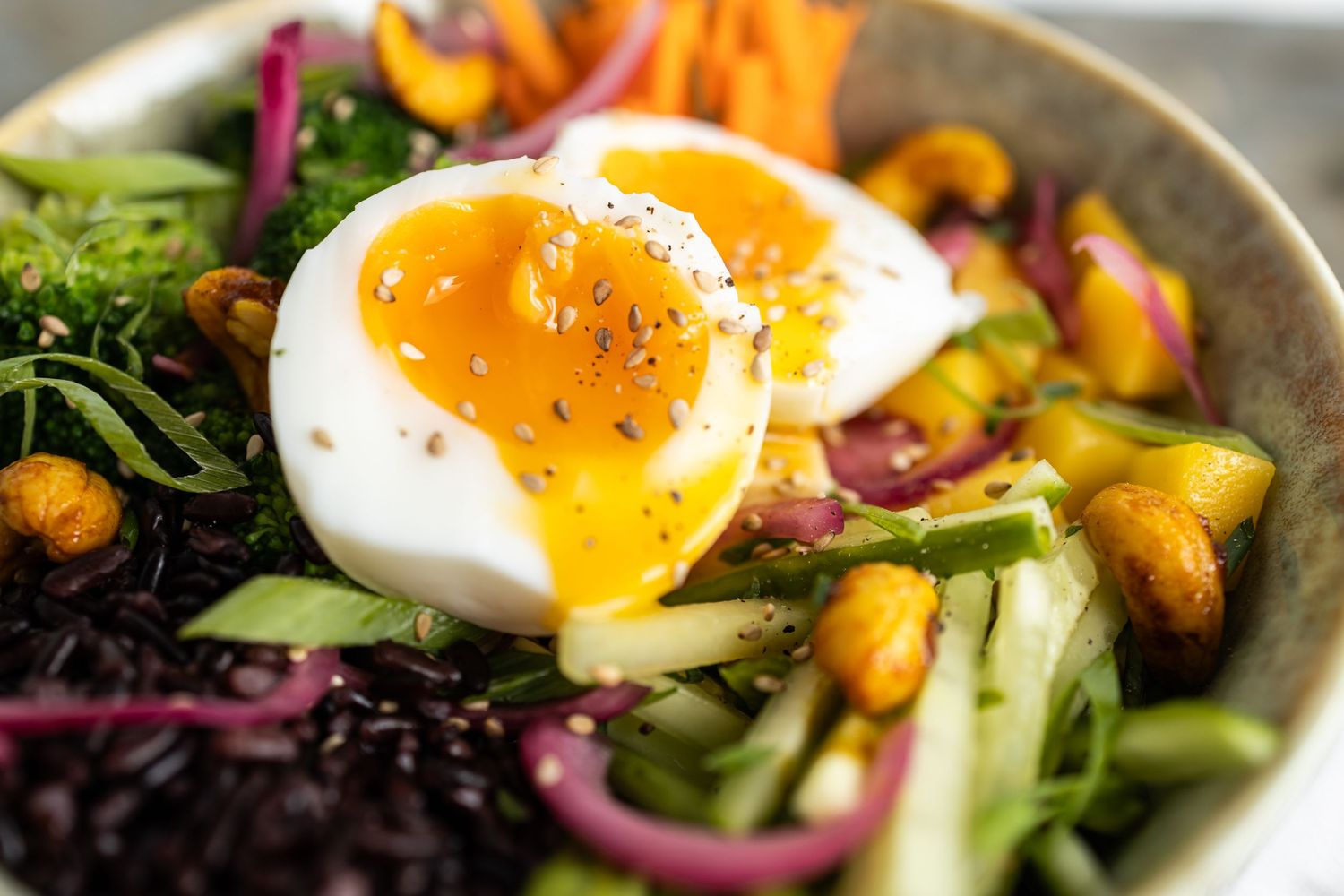 runny egg split on top of chopped salad