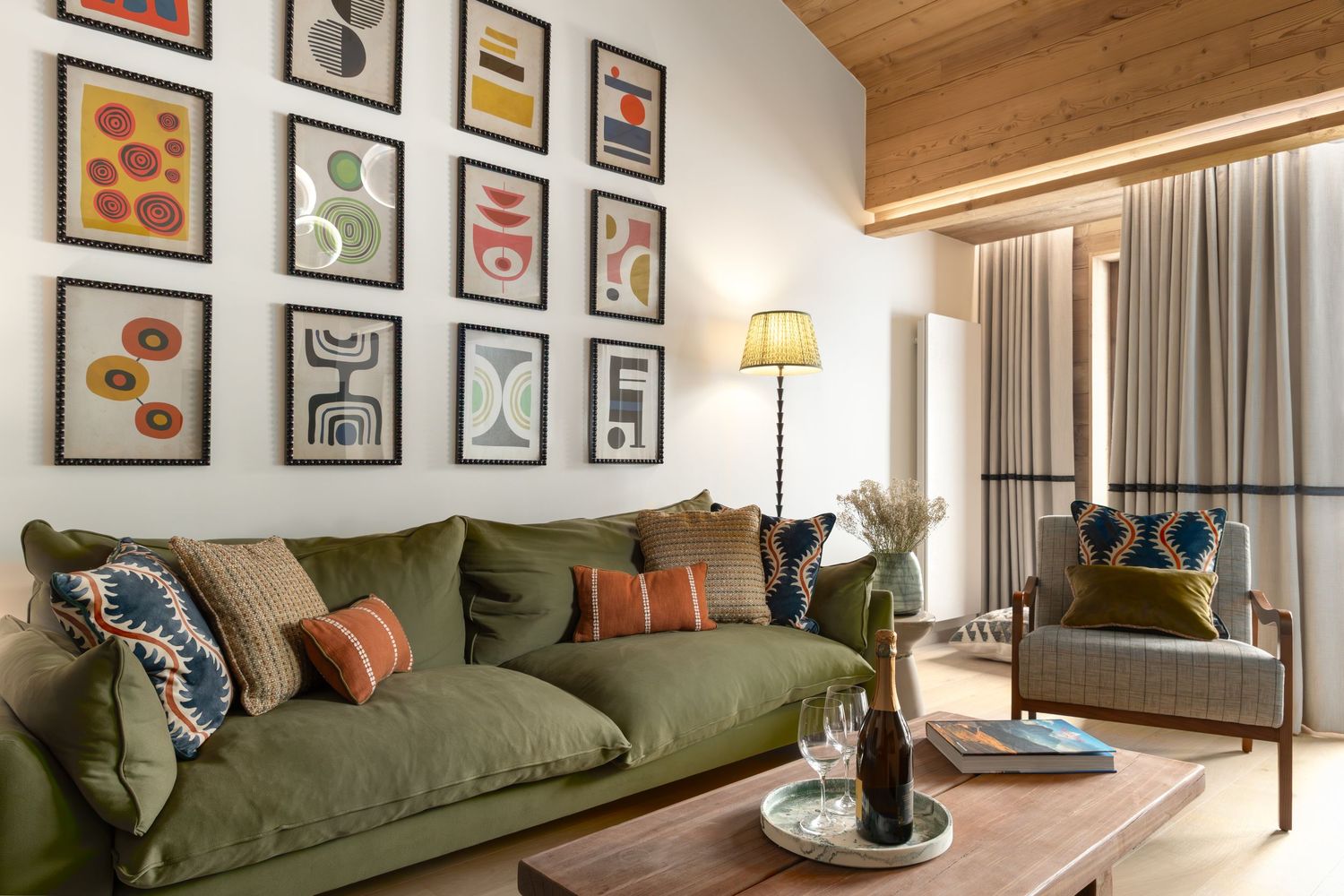 green sofa in front of art work in ski chalet apartment