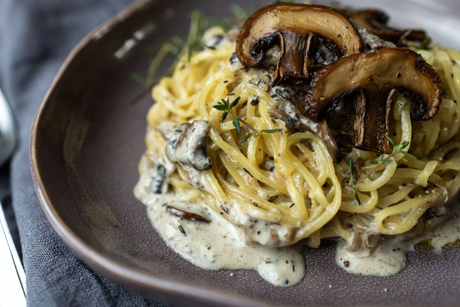 plate of fresh spaghetti with mushrooms and creamy sauce