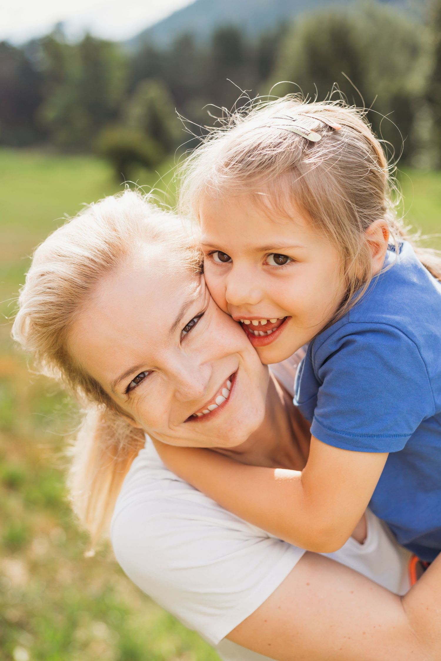 mother and young daughter embrace closely