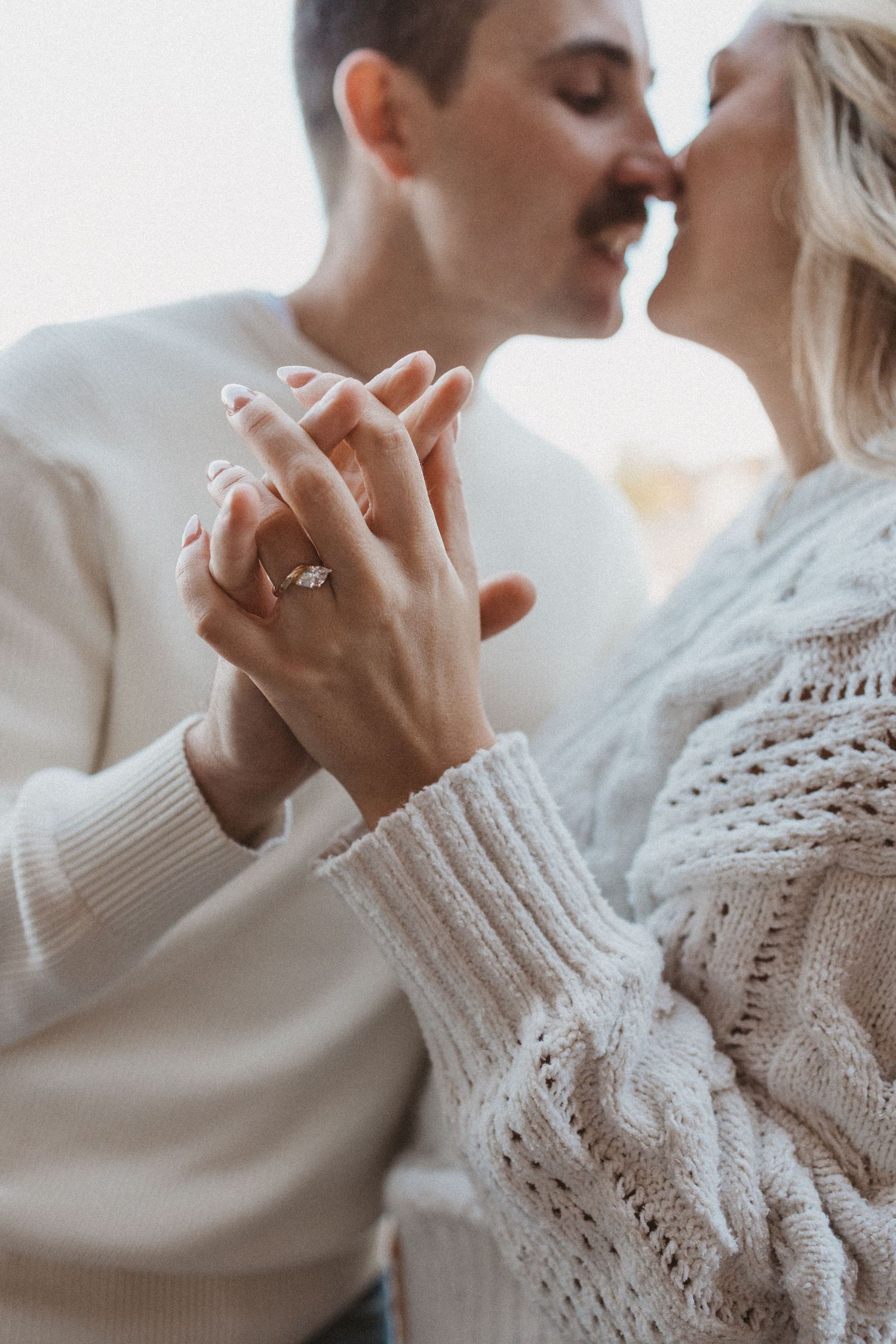 man and woman almost kiss while holding hands