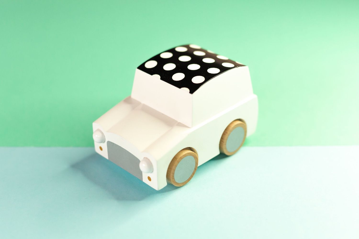 toy car sitting on background with two shades of green