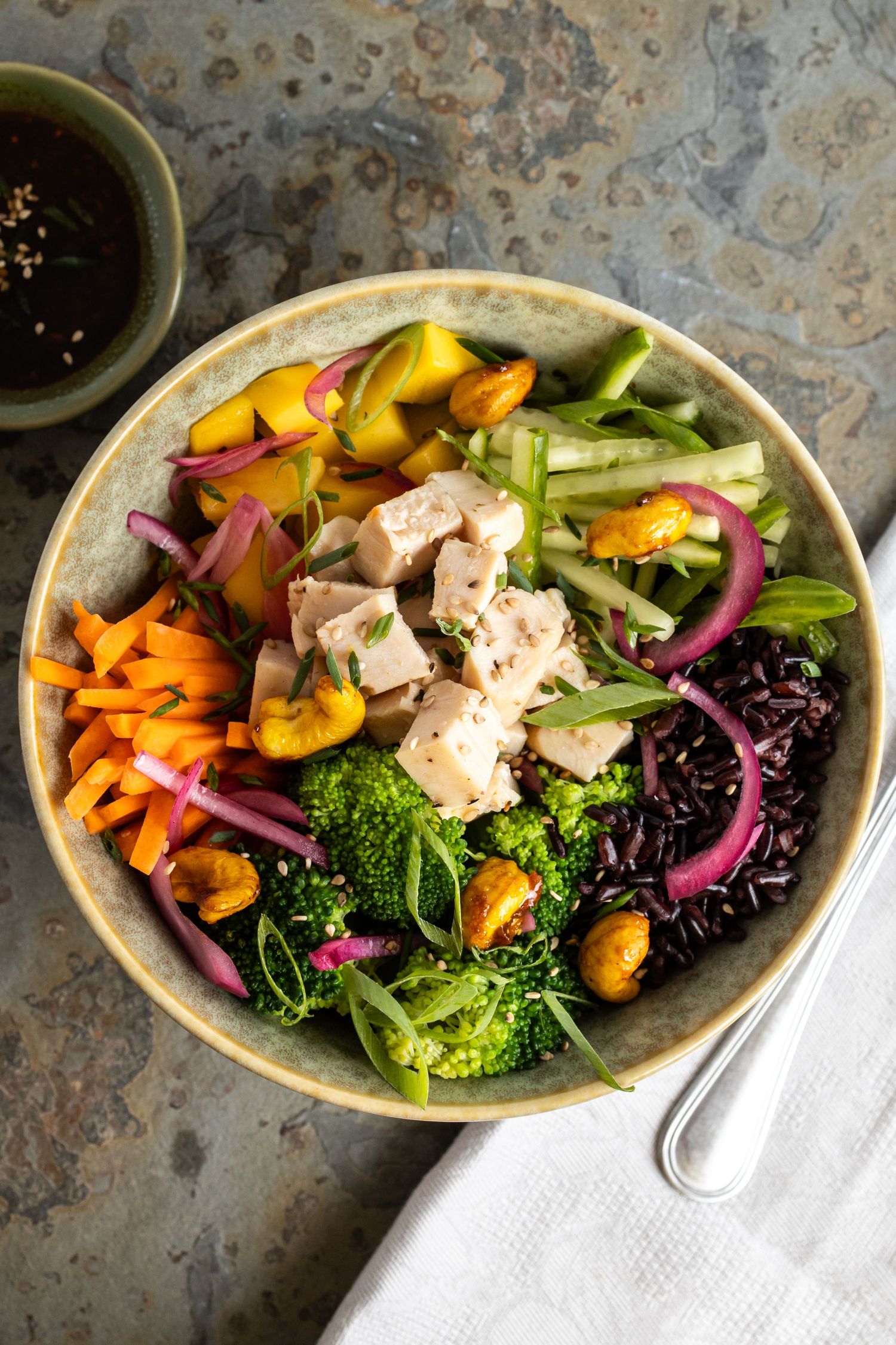 tofu salad in bowl on board with napkin