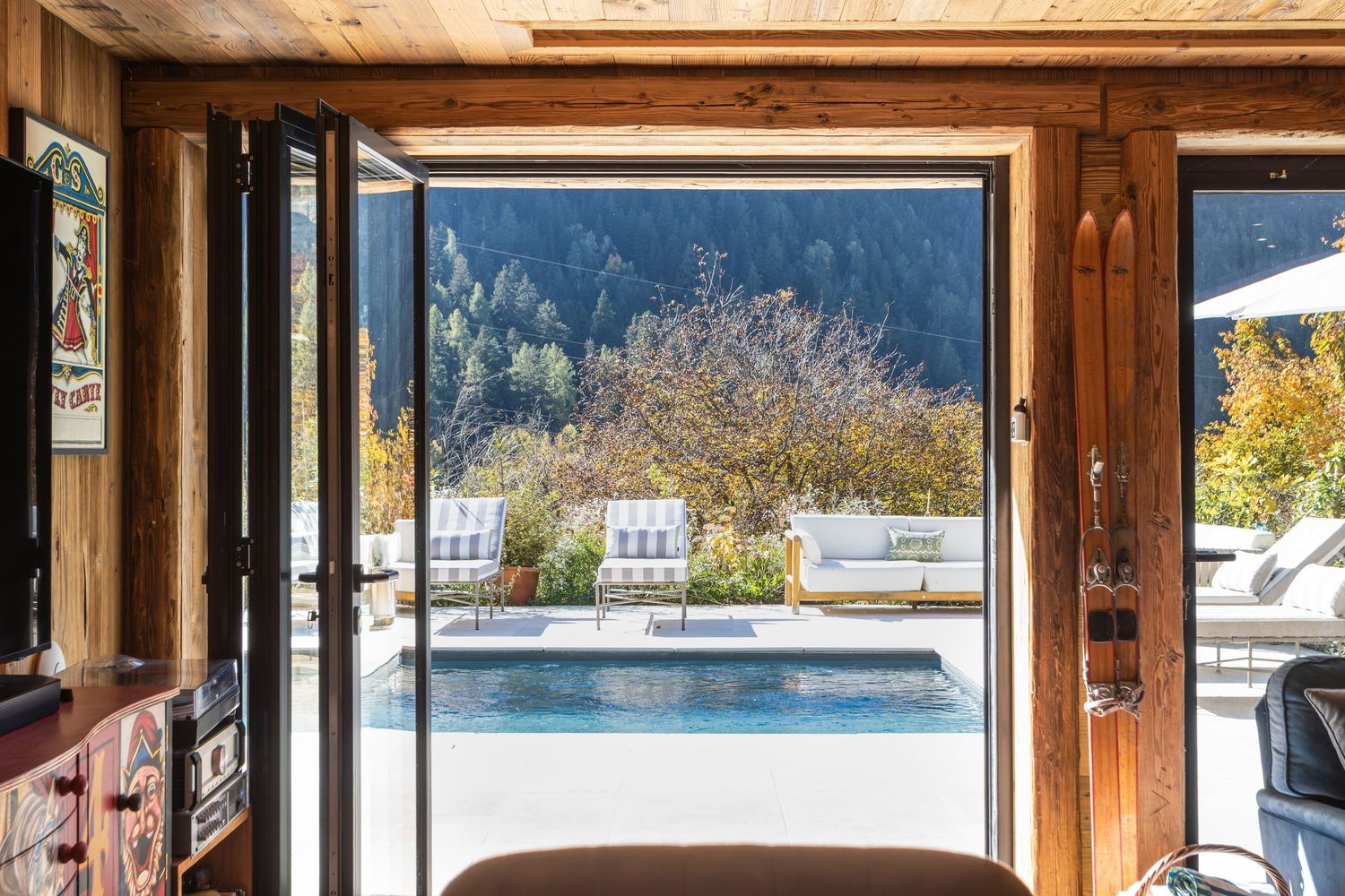 double doors open overlooking swimming pool in French alps