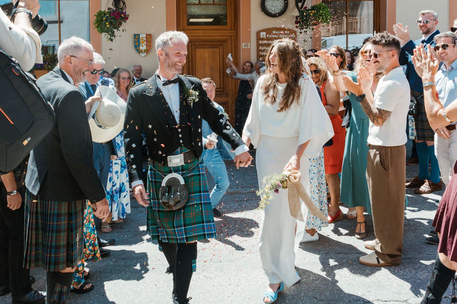 bride and groom leave Marie while guests thrown confetti